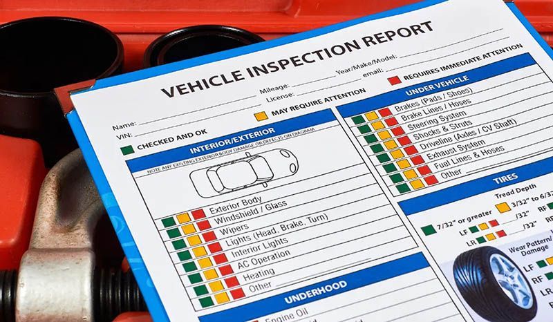 A Vehicle Inspection Report Is Sitting On Top Of A Toolbox — Manning Smash & Auto Repairs In Forster, NSW