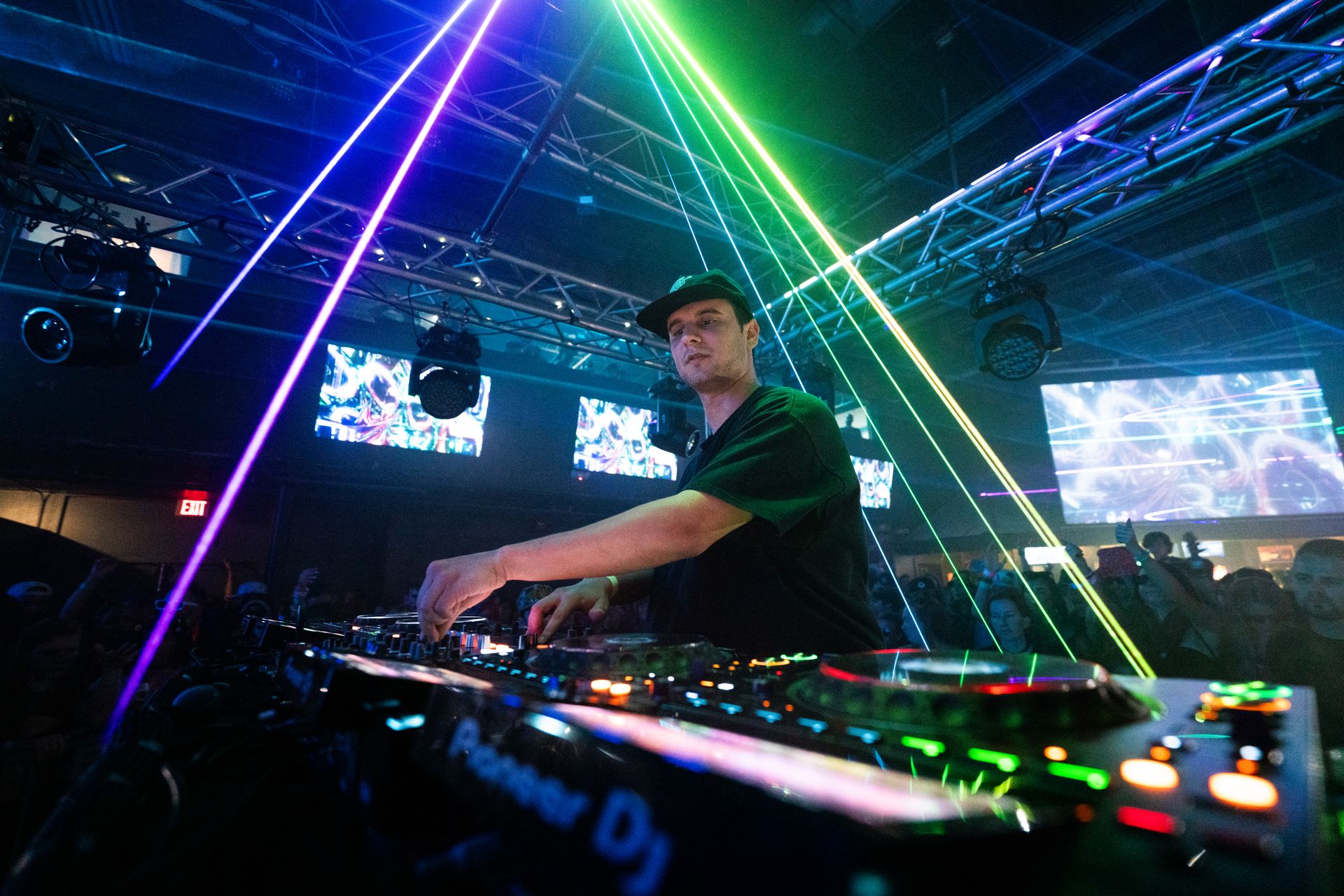 A man is playing a dj set in a club.