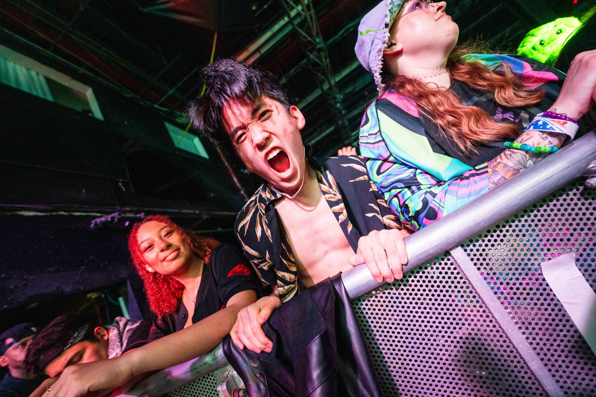 A group of people are standing in a crowd at a concert.
