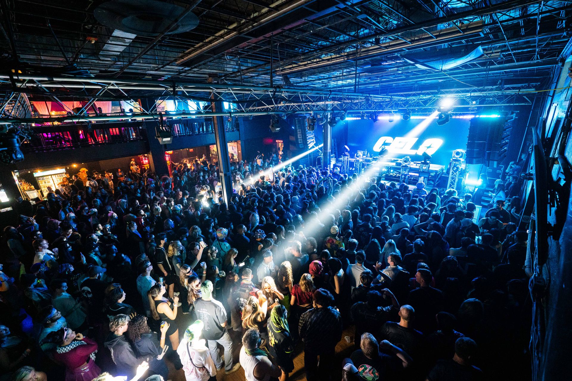 A large crowd of people at a concert with the word gala on the stage