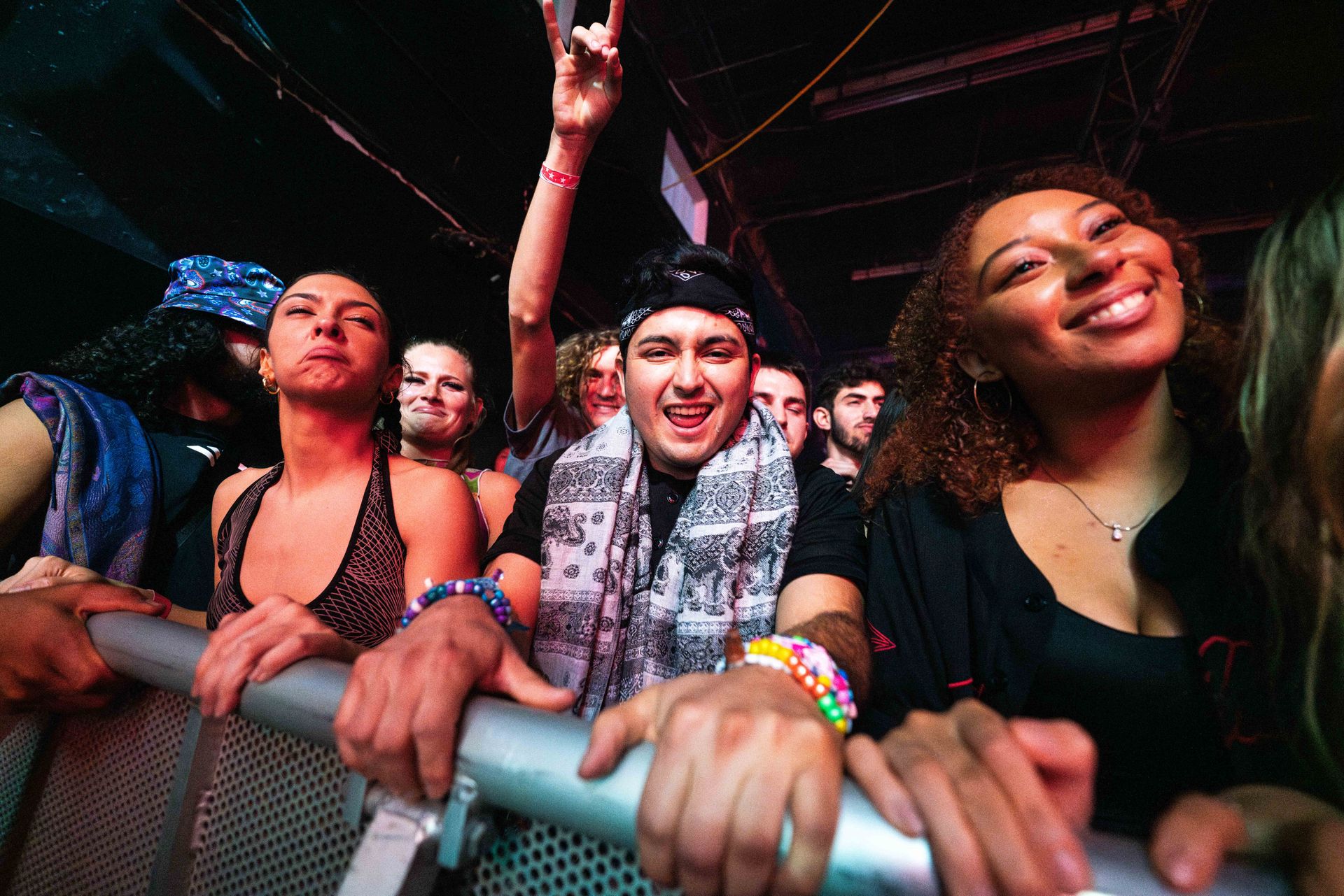 A group of people are standing in a crowd at a concert.