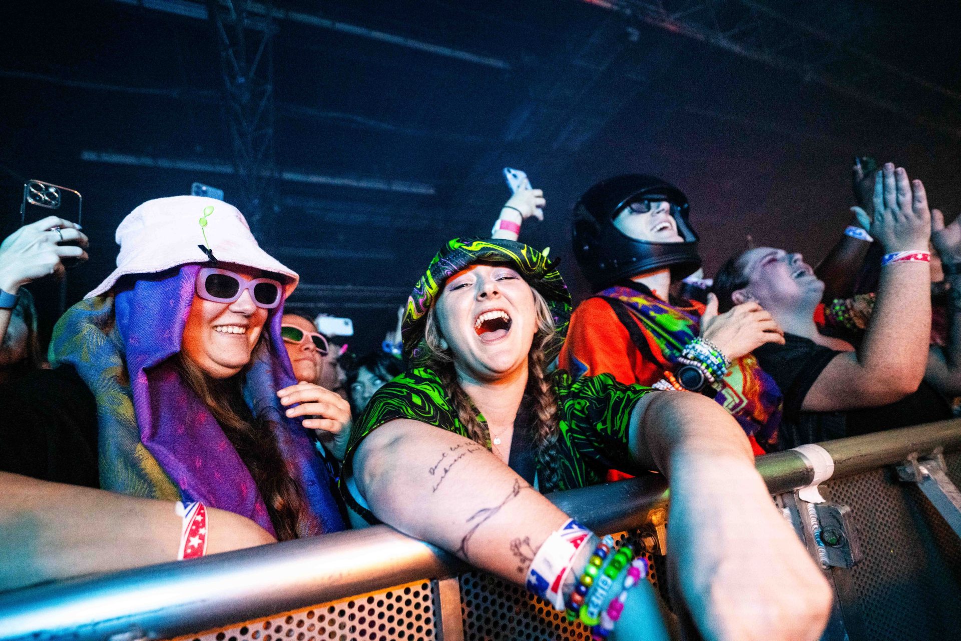 A group of people are sitting in a crowd at a concert.