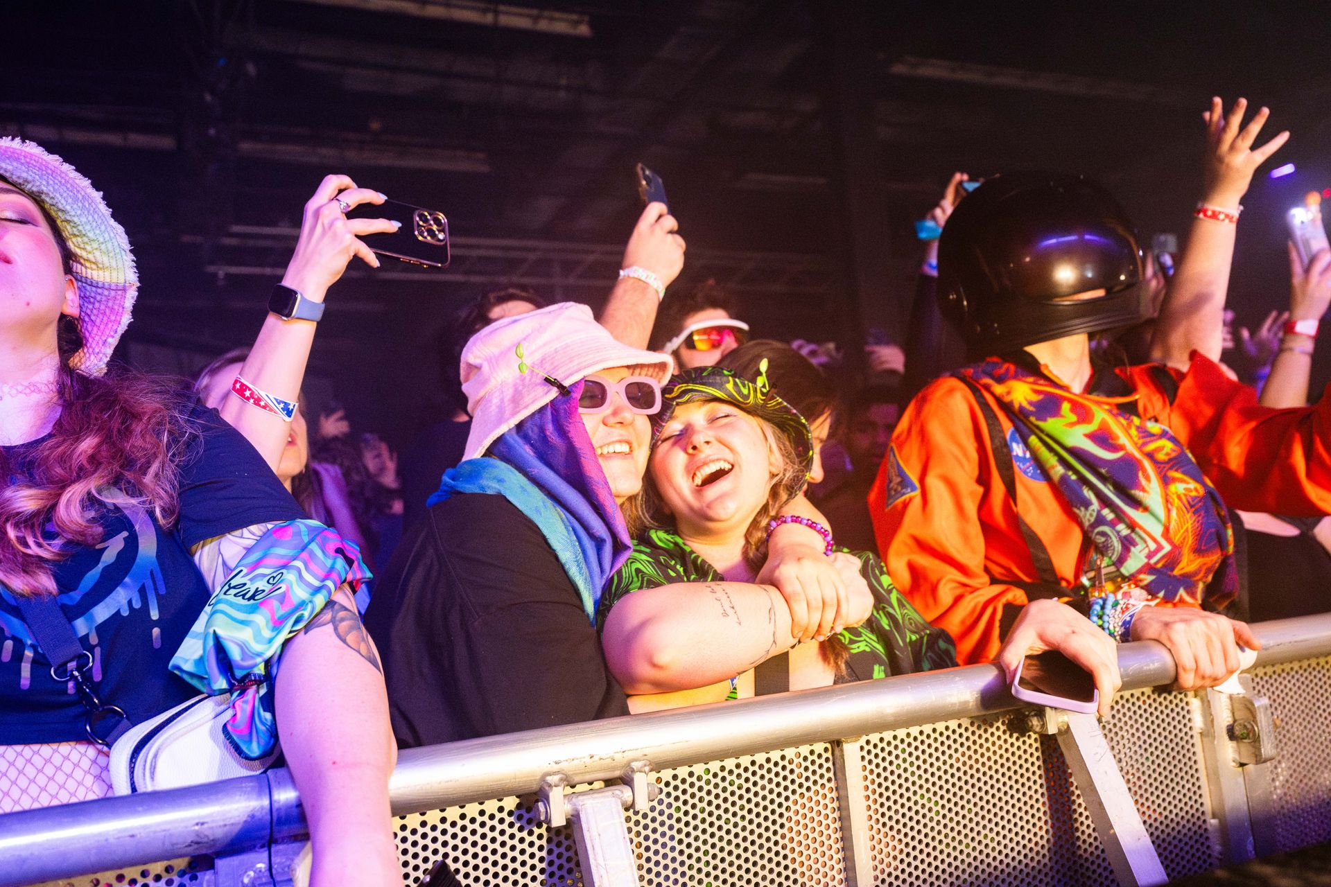 A group of people are standing in a crowd at a concert.