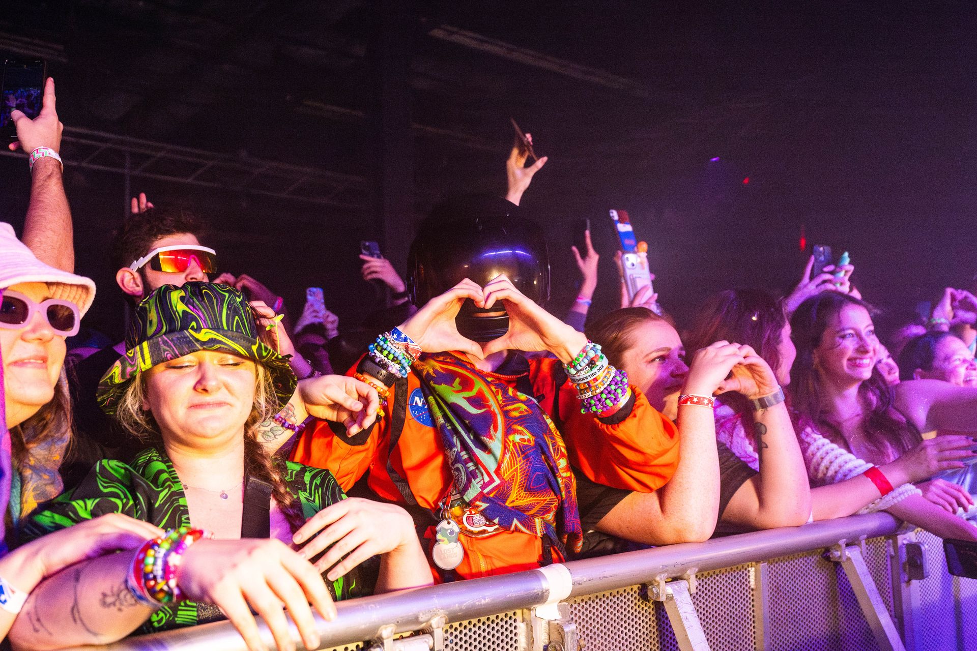 A group of people are standing in a crowd at a concert.