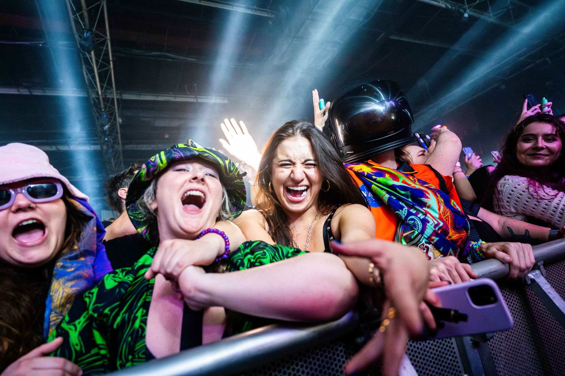 A group of people are standing in a crowd at a concert.