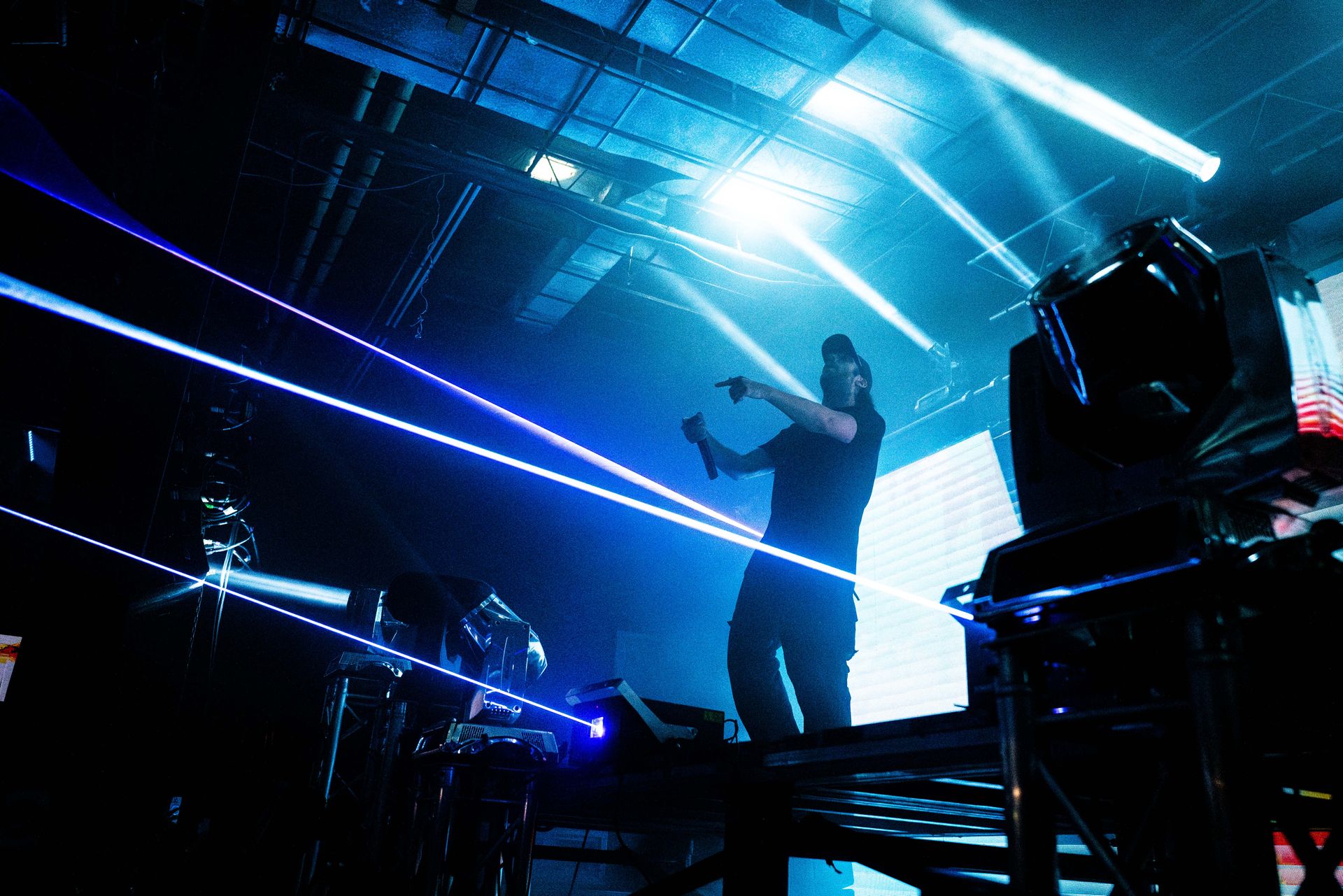 A man singing into a microphone on a stage