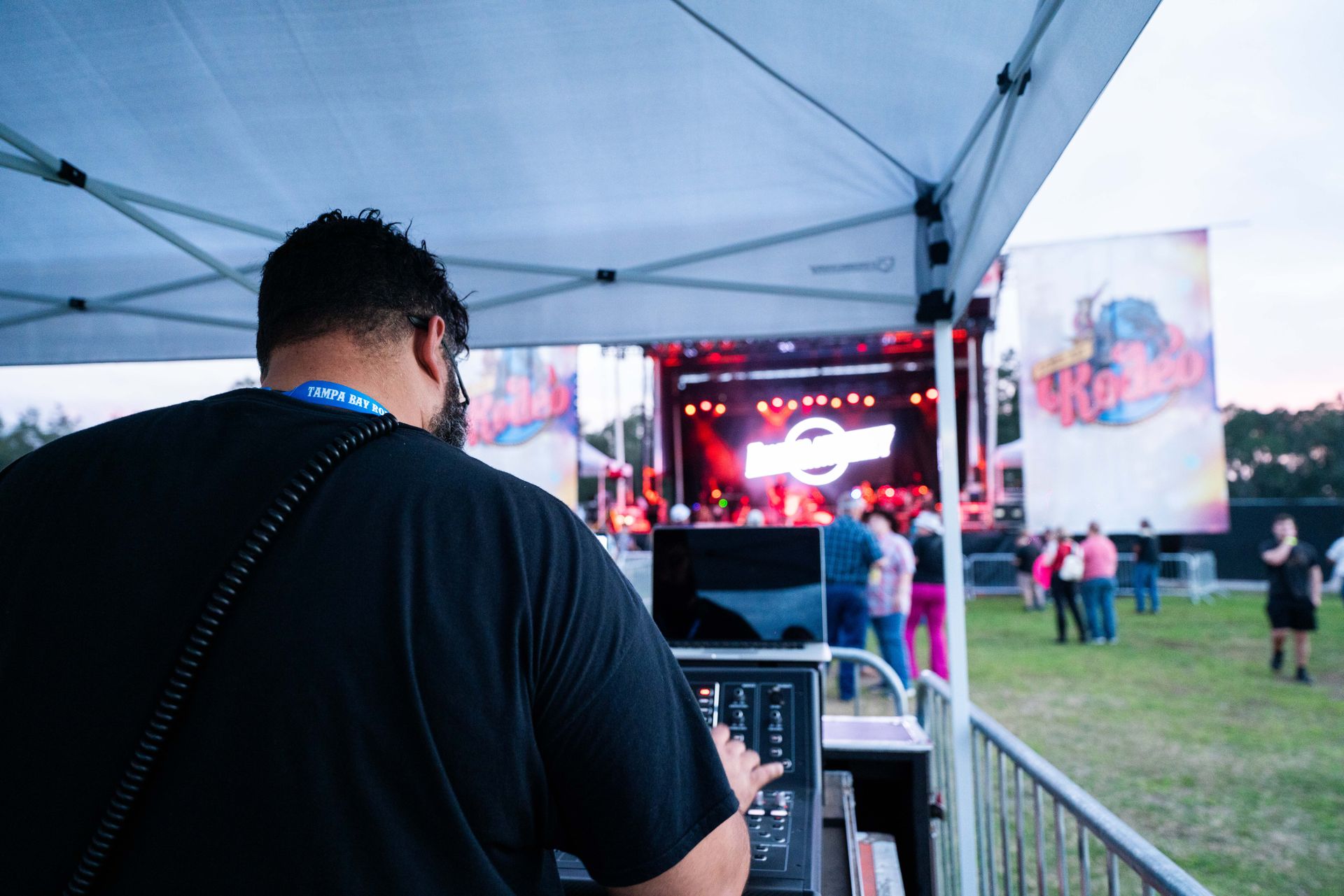 A man is standing in front of a stage at a concert.