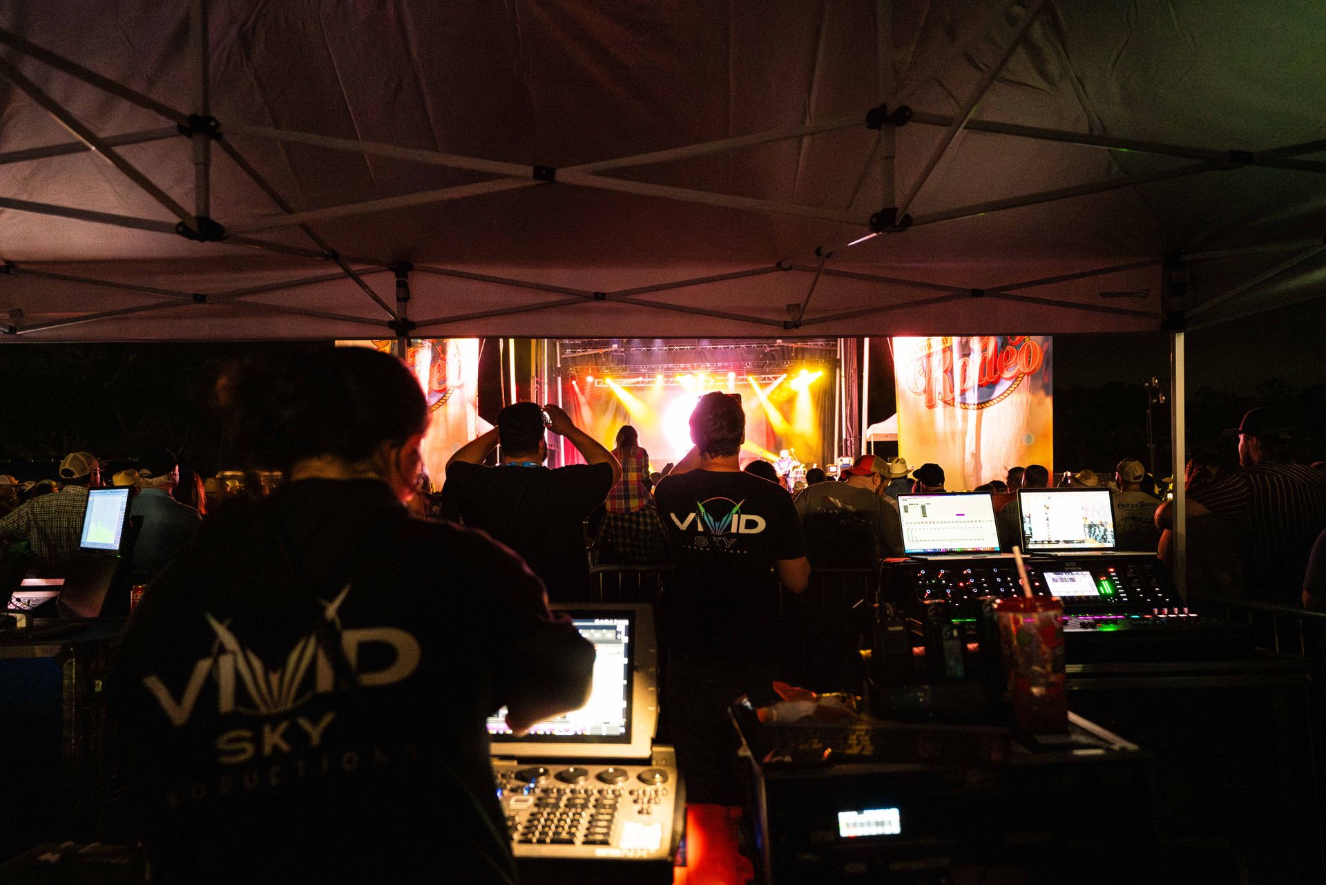 A man wearing a shirt that says vivid sky on it