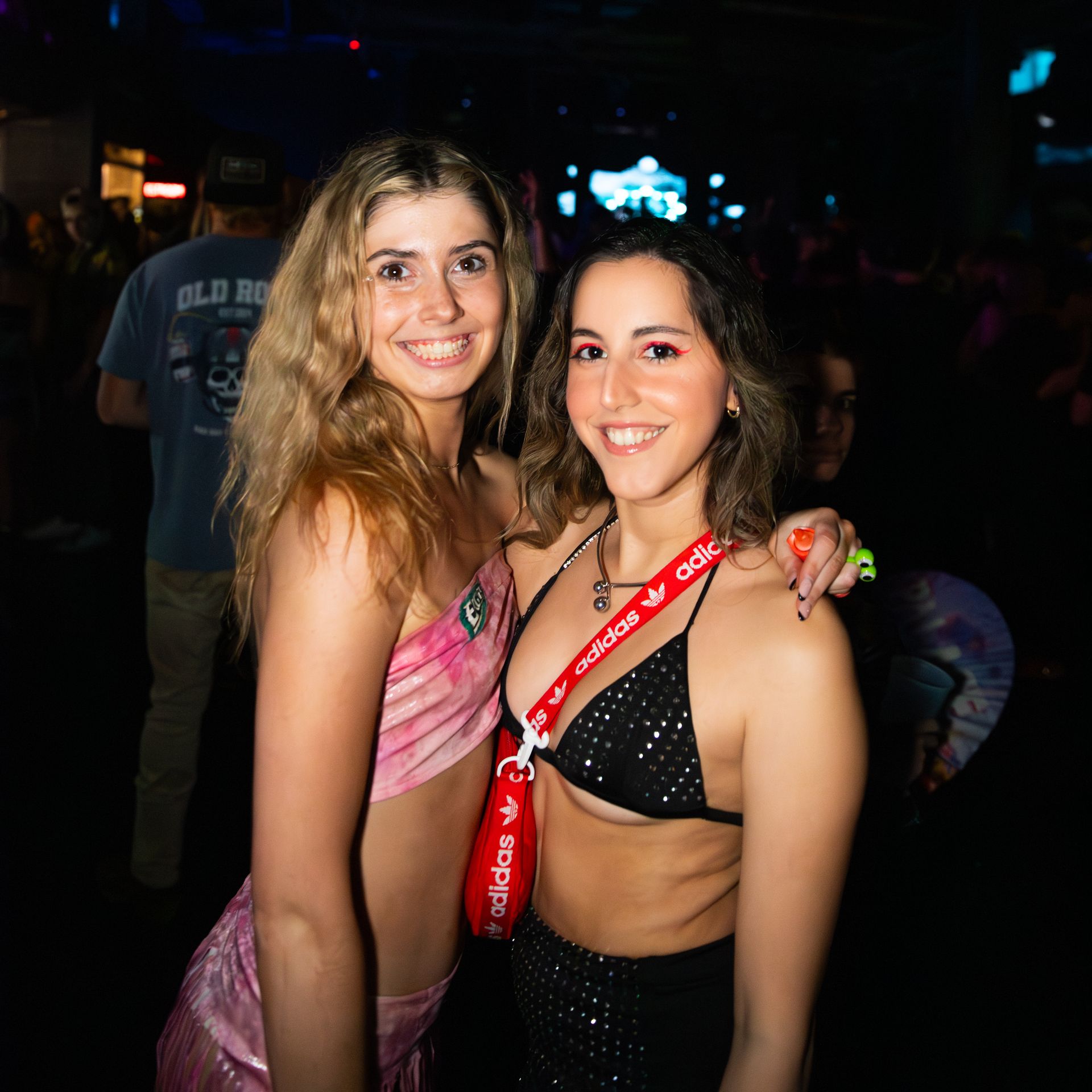Two women are posing for a picture together at a party.