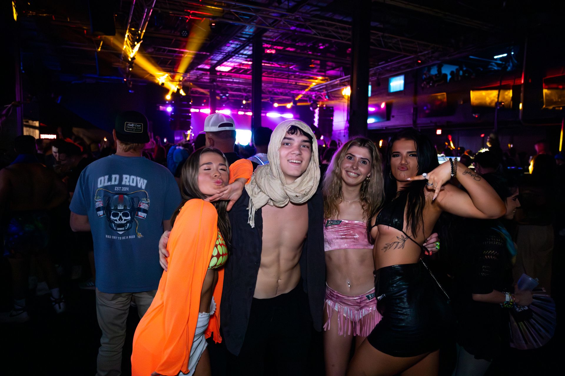 A group of people are posing for a picture at a party.