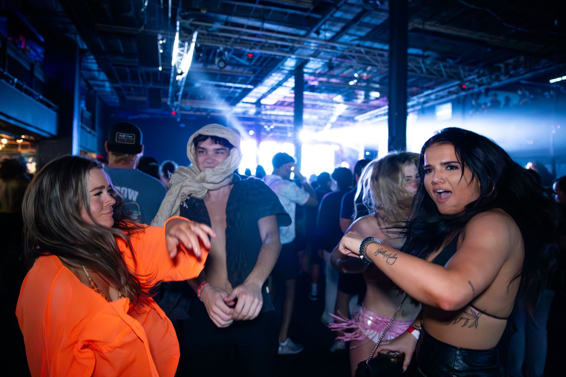 A group of people are dancing in a club.