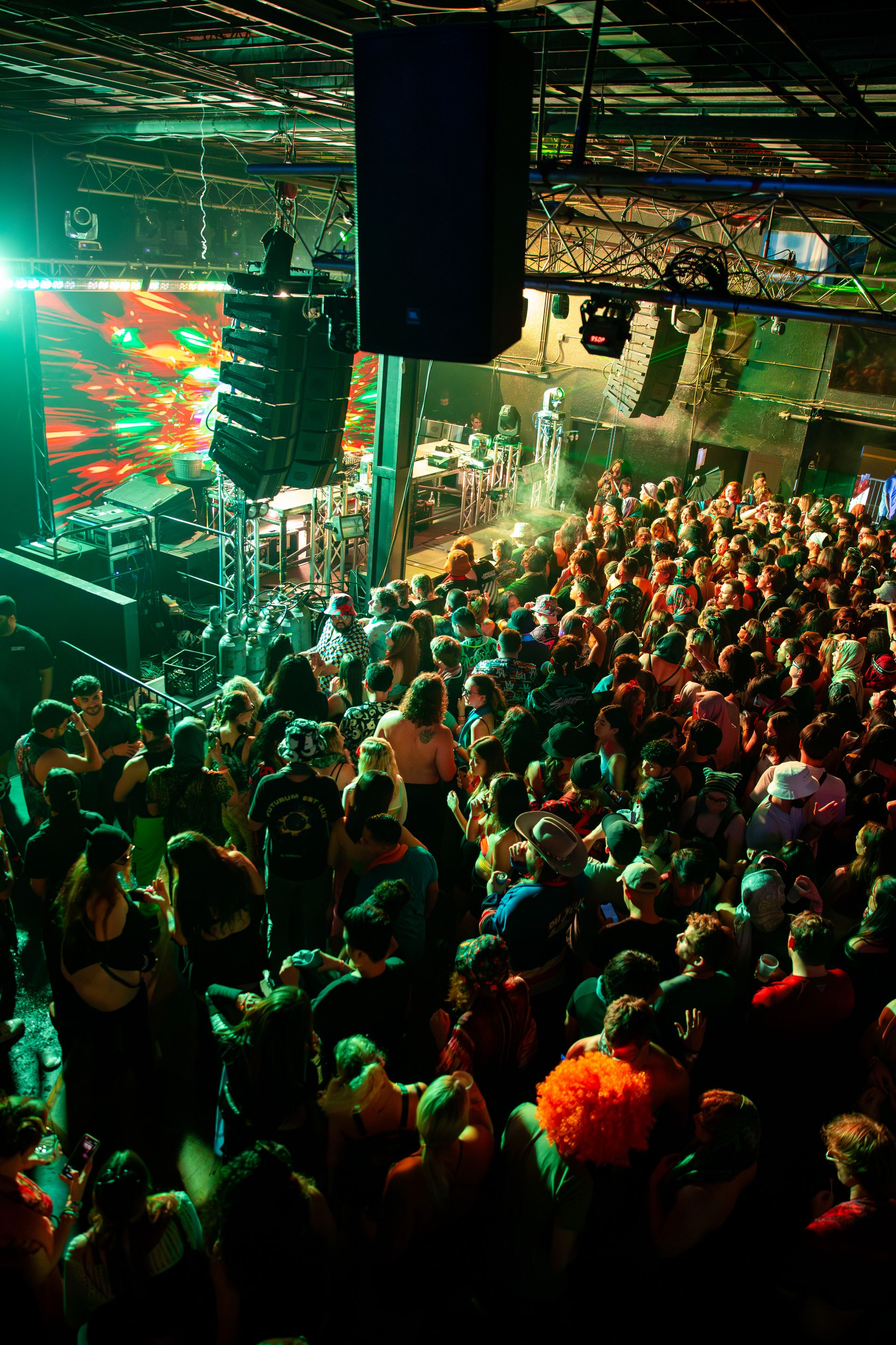 A crowd of people are gathered in a large room at a concert.