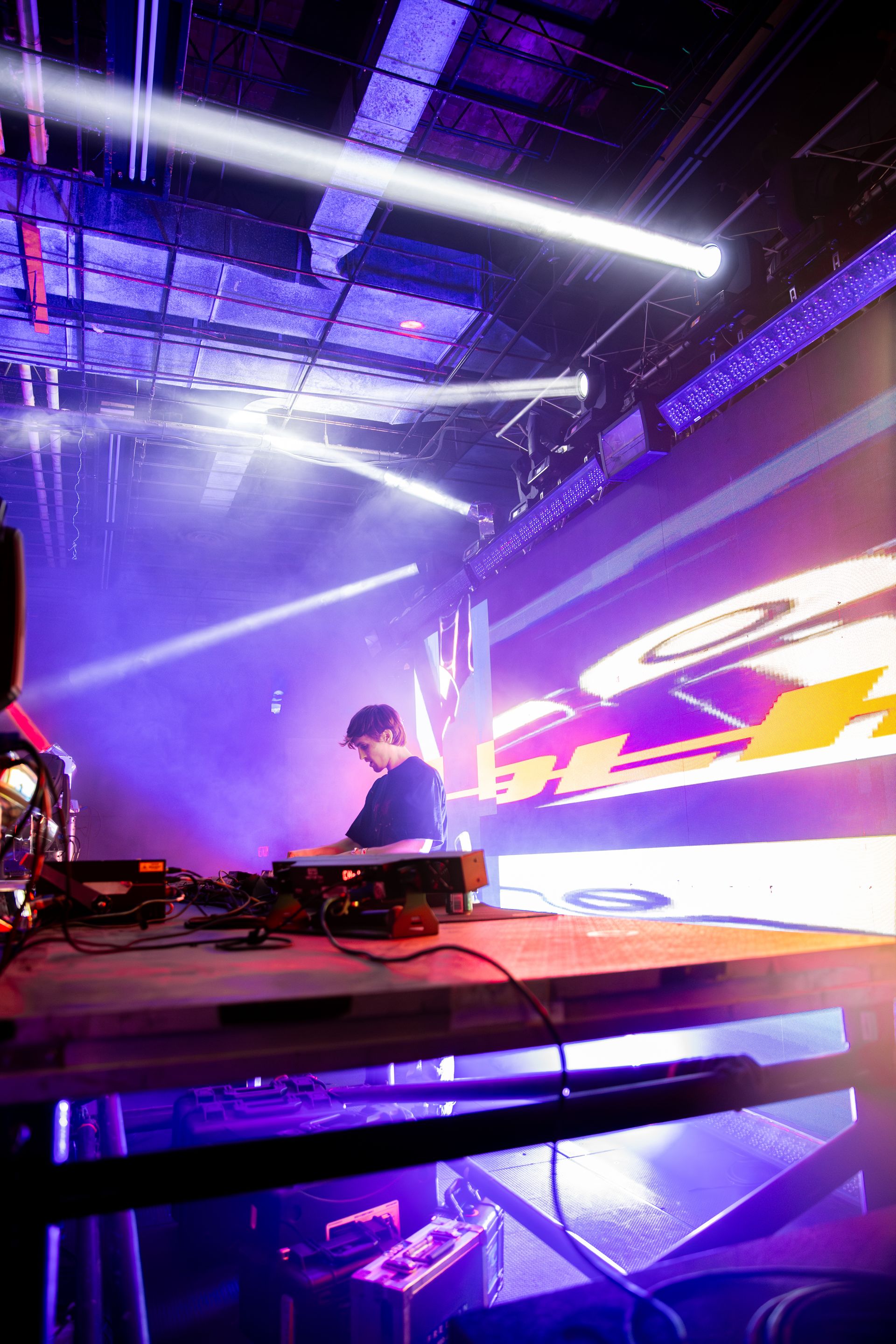 A man is playing a keyboard on a stage at a concert.