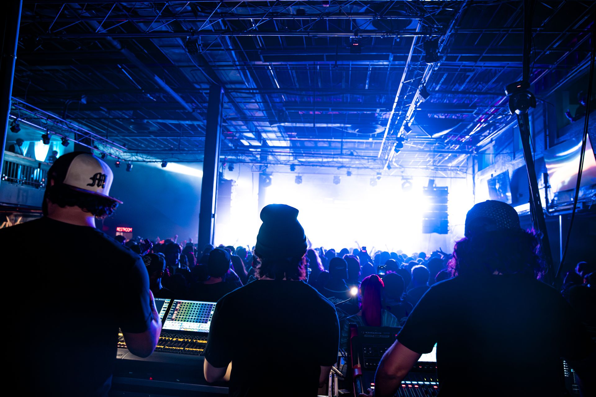 A group of people standing in front of a stage at a concert