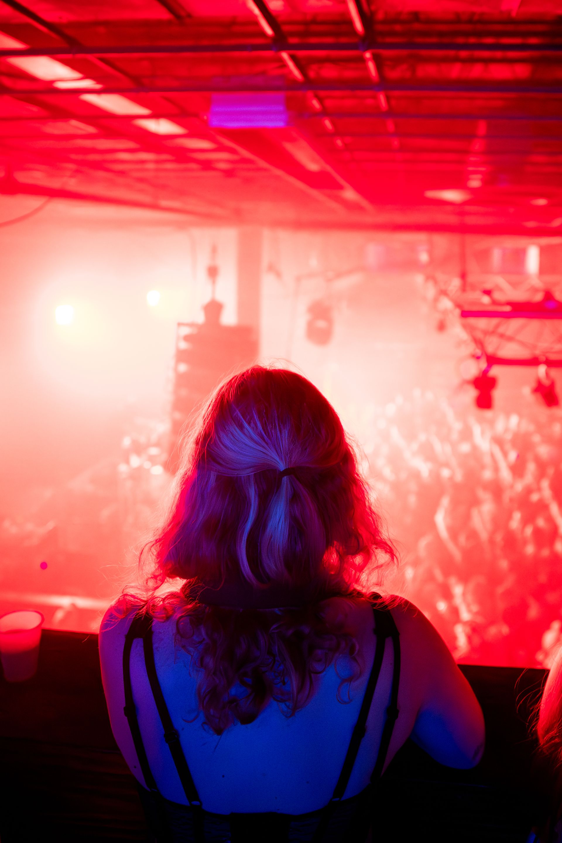 A woman is sitting in front of a crowd at a concert.