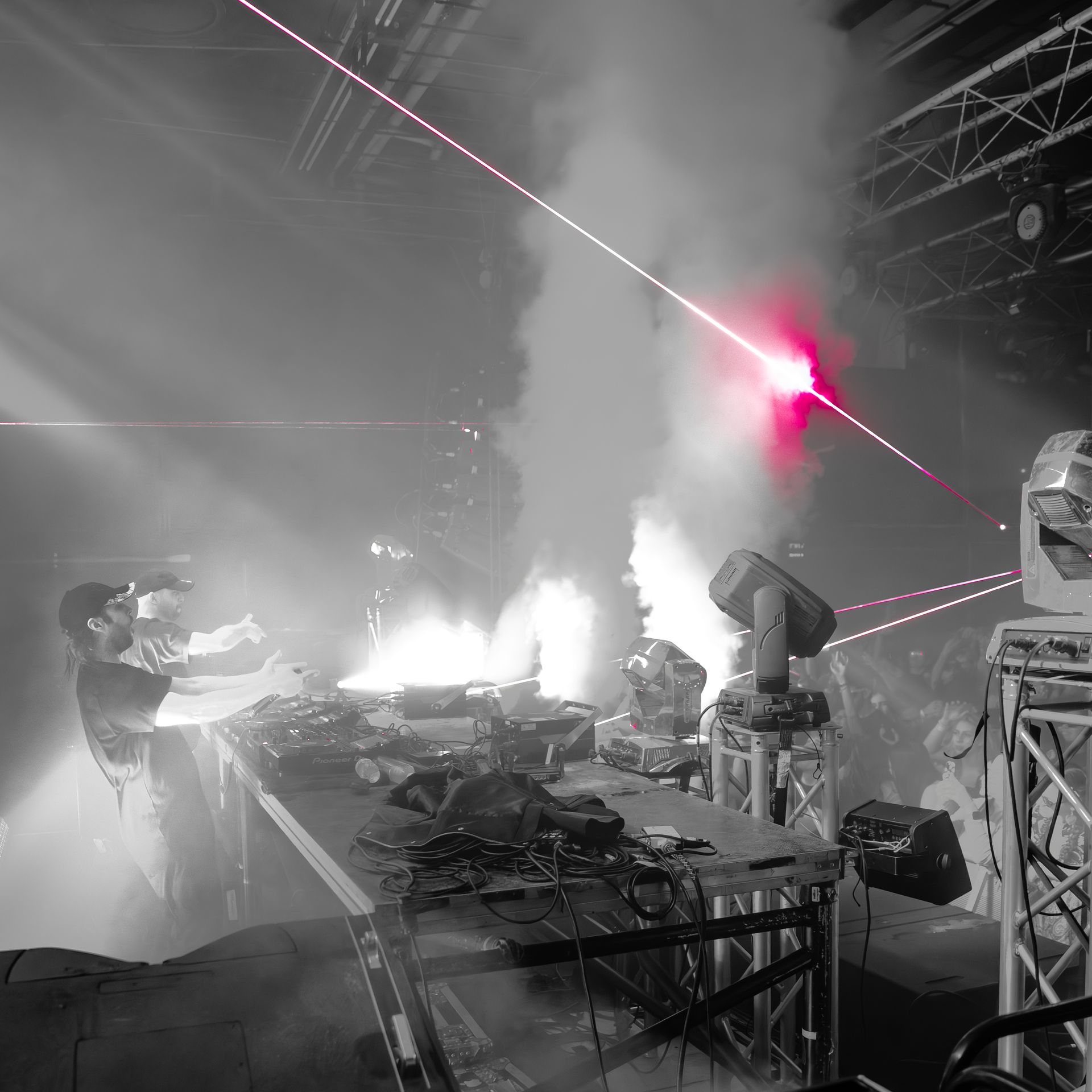 A black and white photo of a stage with smoke coming out of it