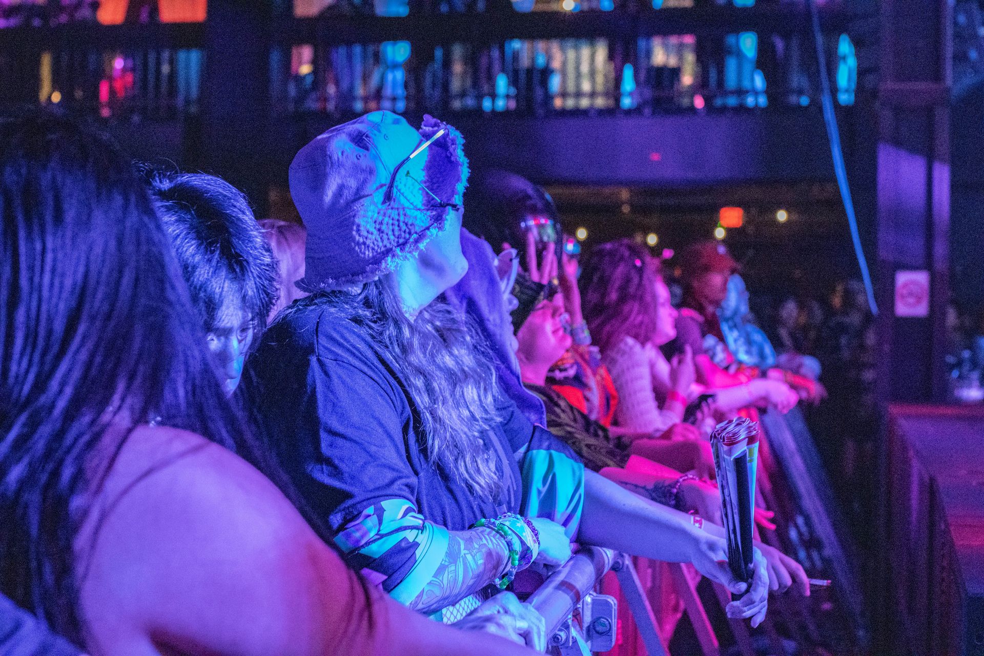 A group of people are sitting in a row at a concert.