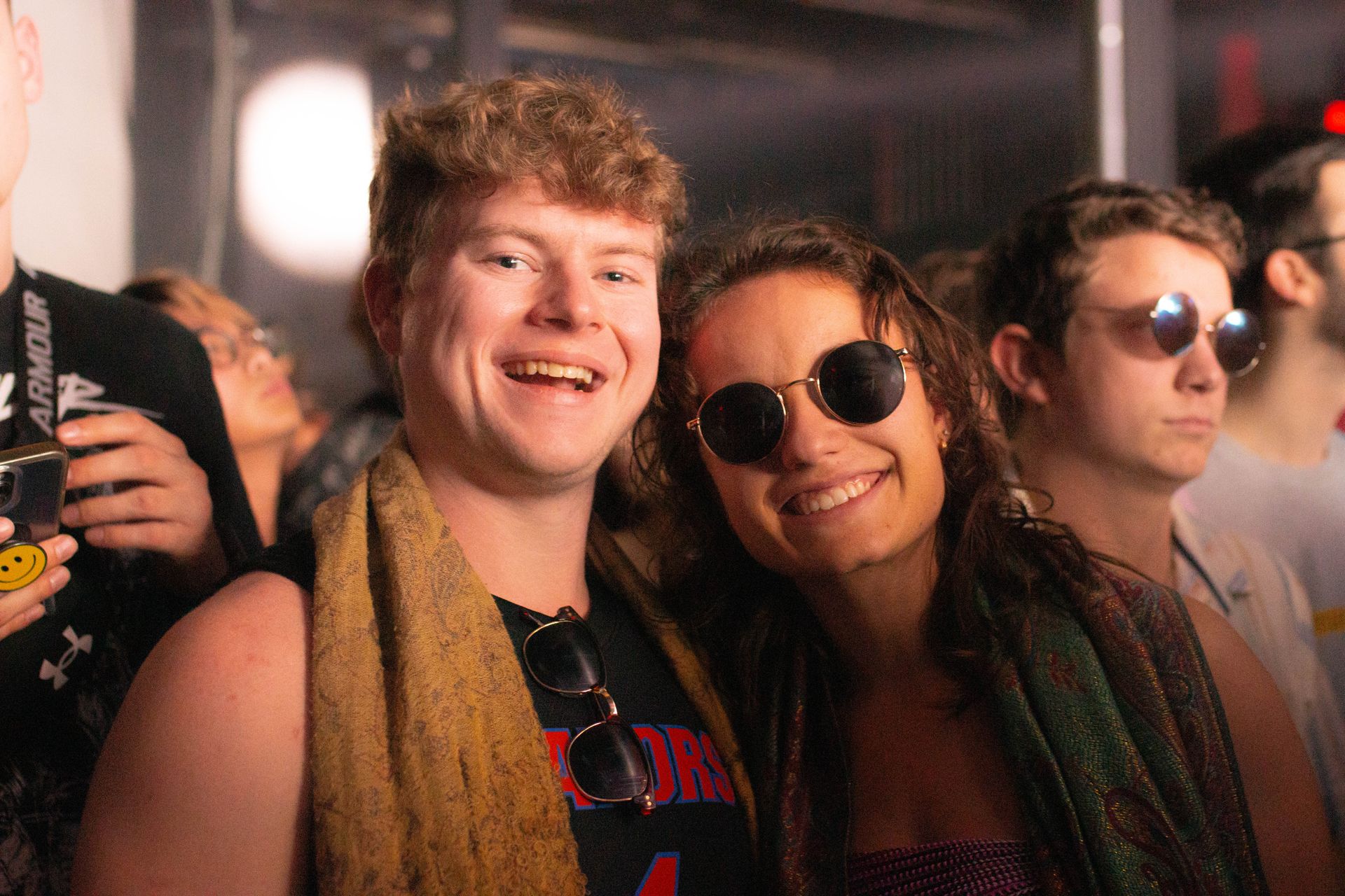 A man and a woman are posing for a picture at a party.