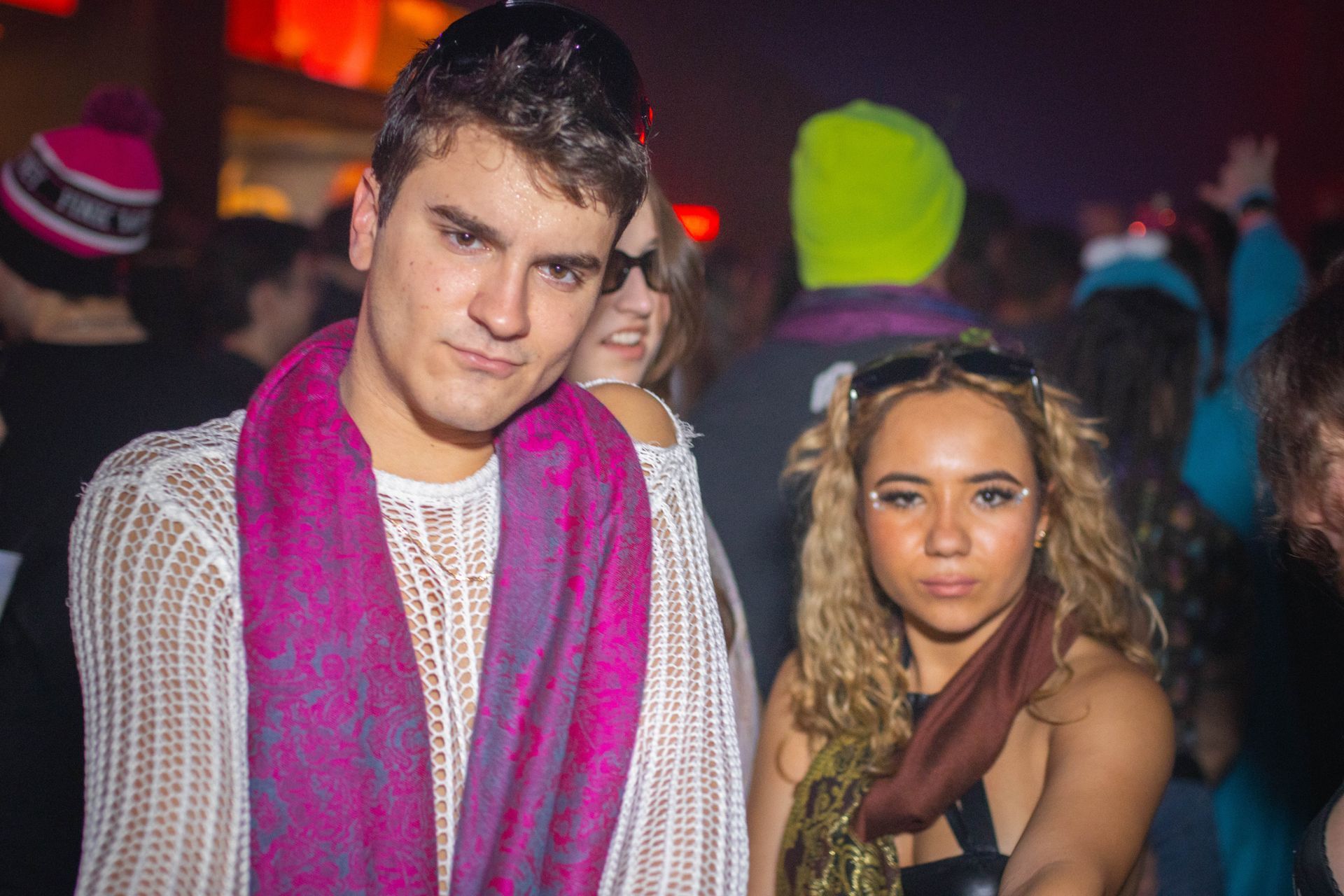 A man and a woman are posing for a picture at a party.