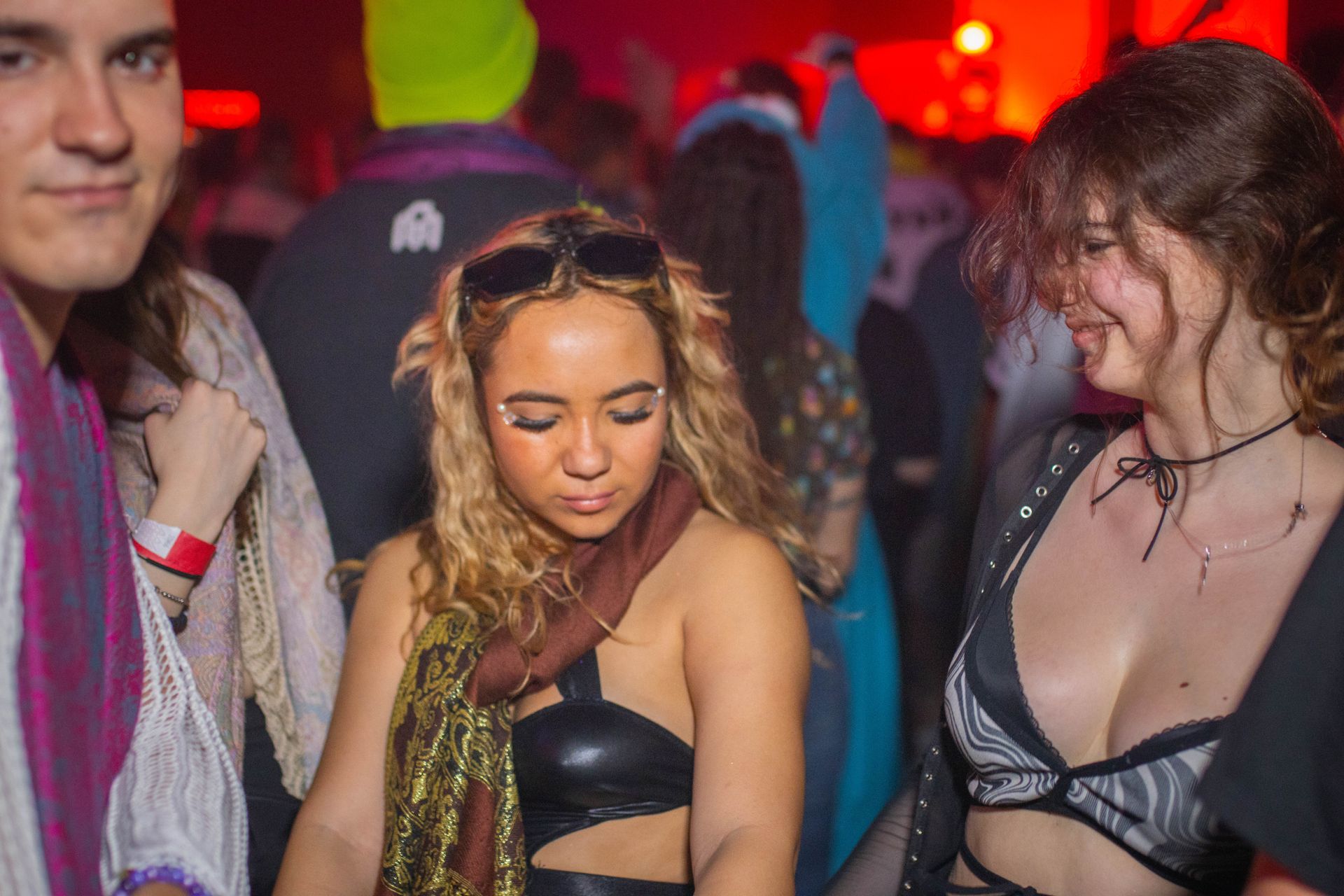 A group of people are standing in a crowd at a party.