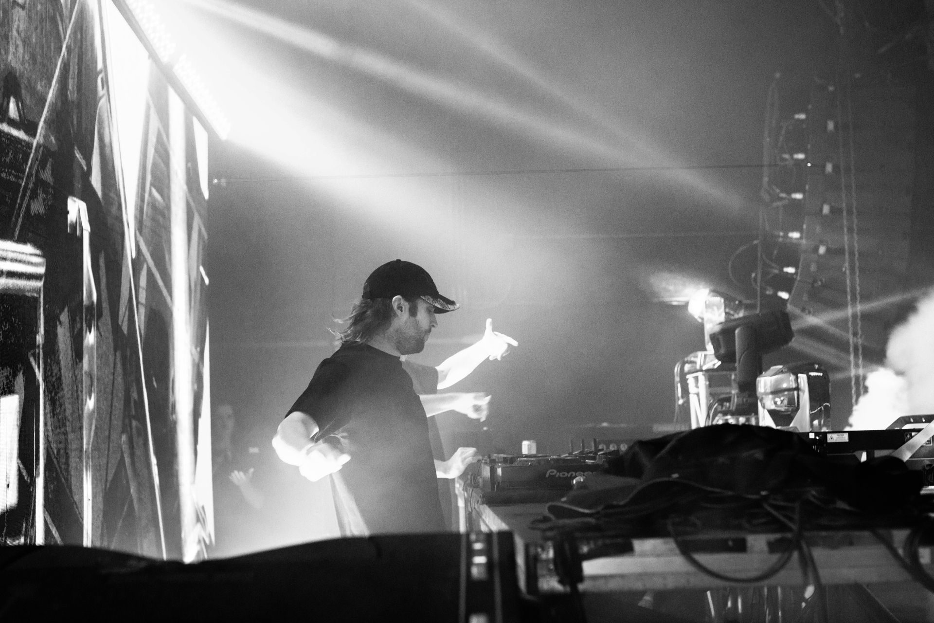 A man is standing on a stage in a black and white photo.
