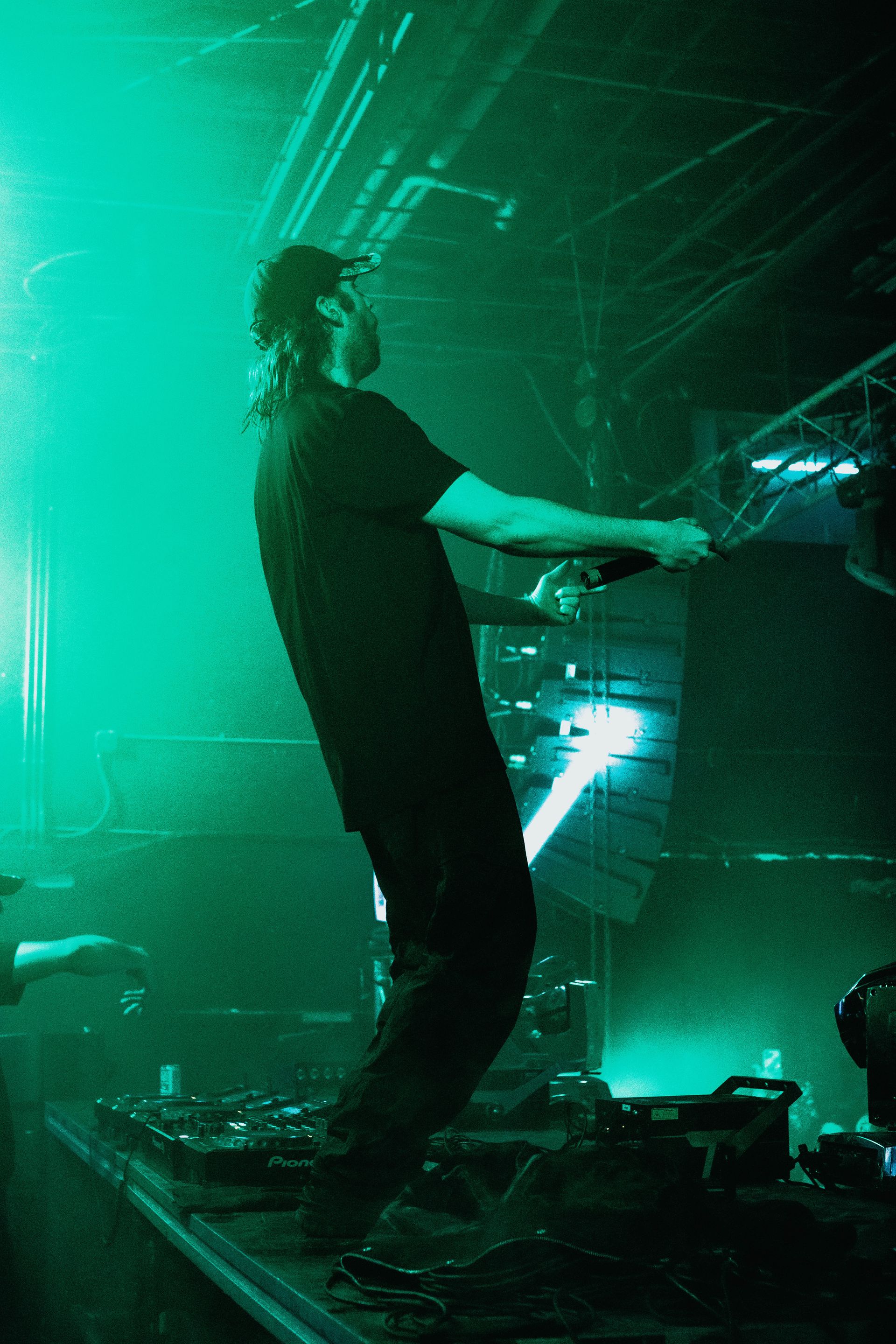 A man is standing on a stage holding a microphone.