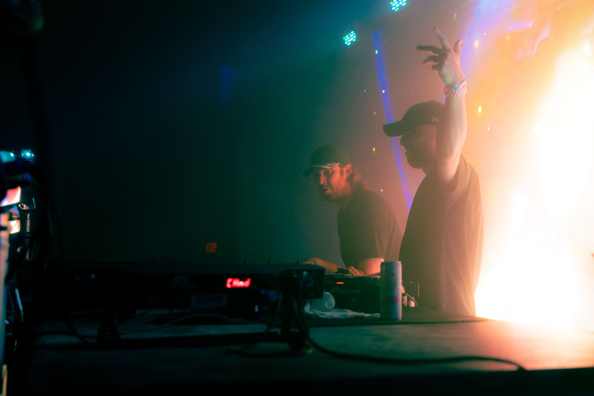 A man is standing on a stage in front of a fire.