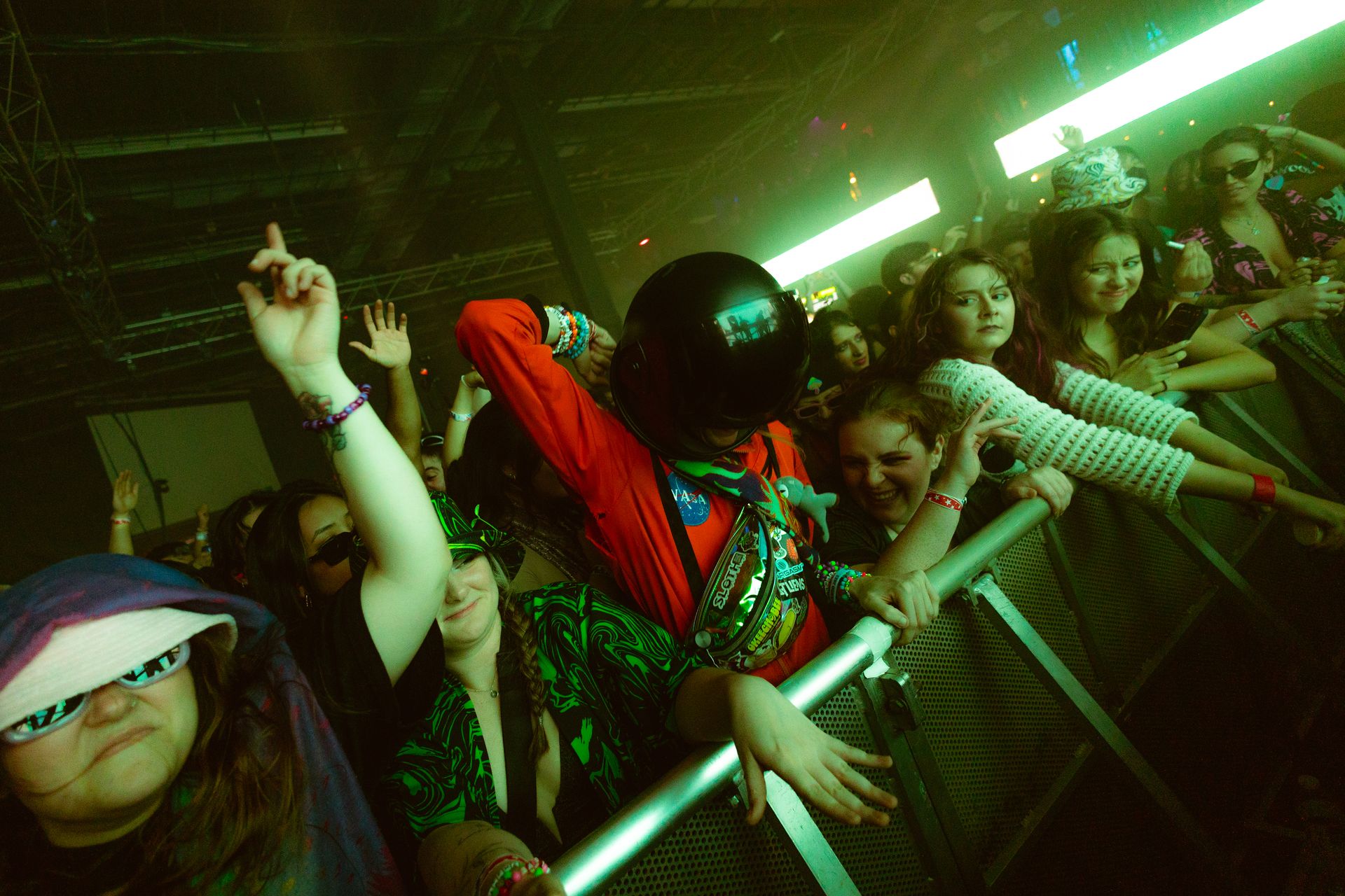 A group of people are standing in a crowd at a concert.