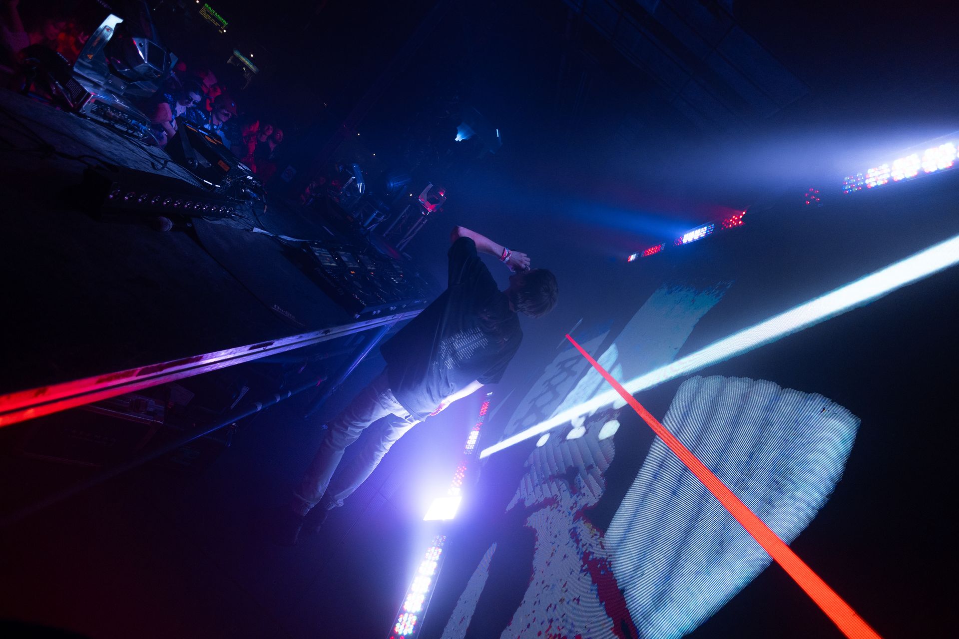 A person is standing in a dark room with a lot of lights.