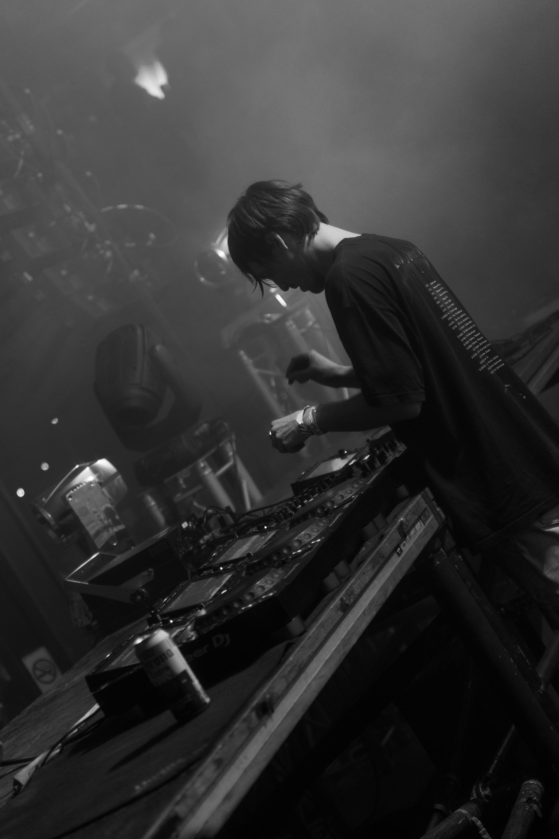 A black and white photo of a man playing a musical instrument on a stage.