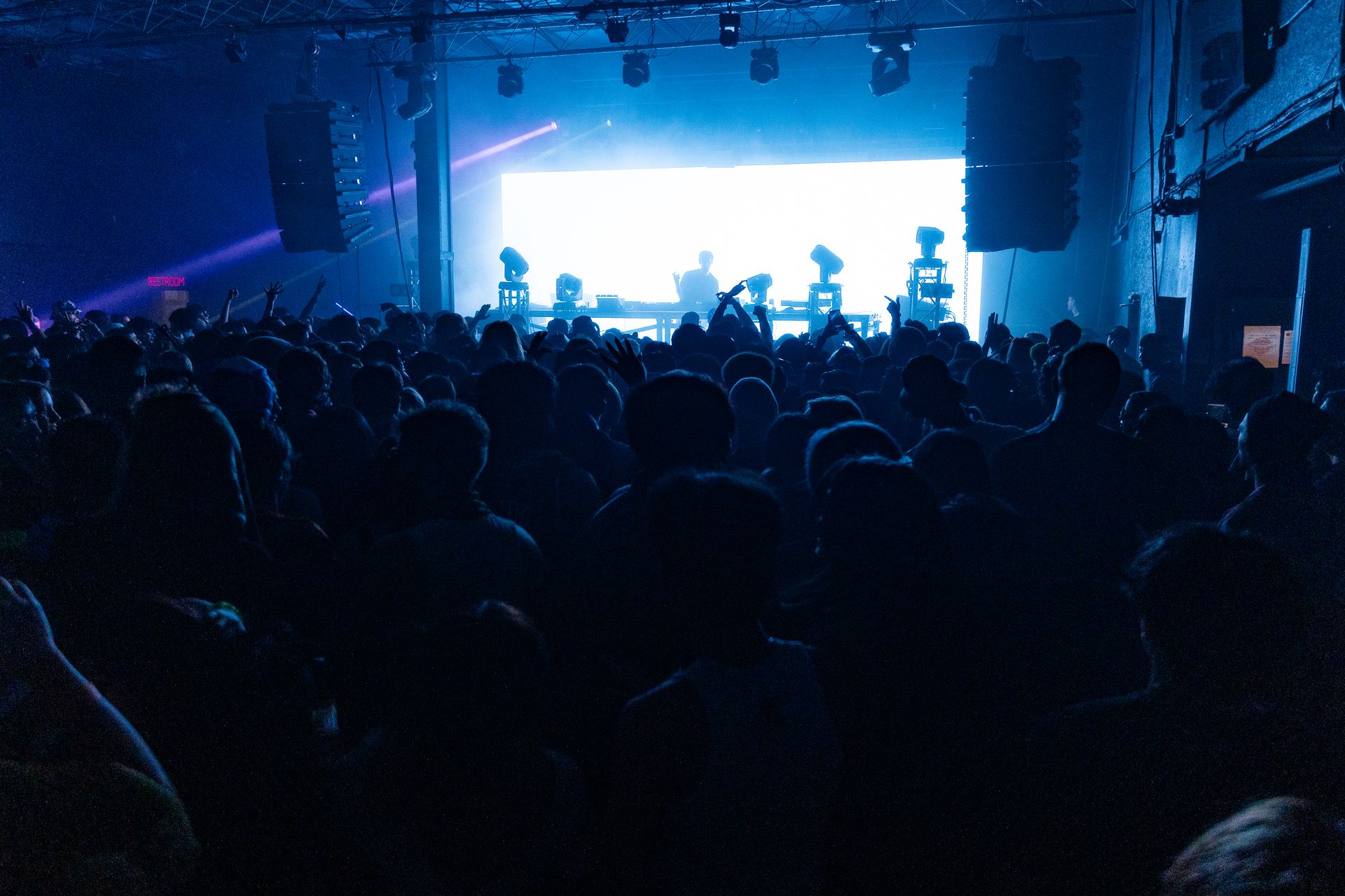 A crowd of people are watching a band on stage