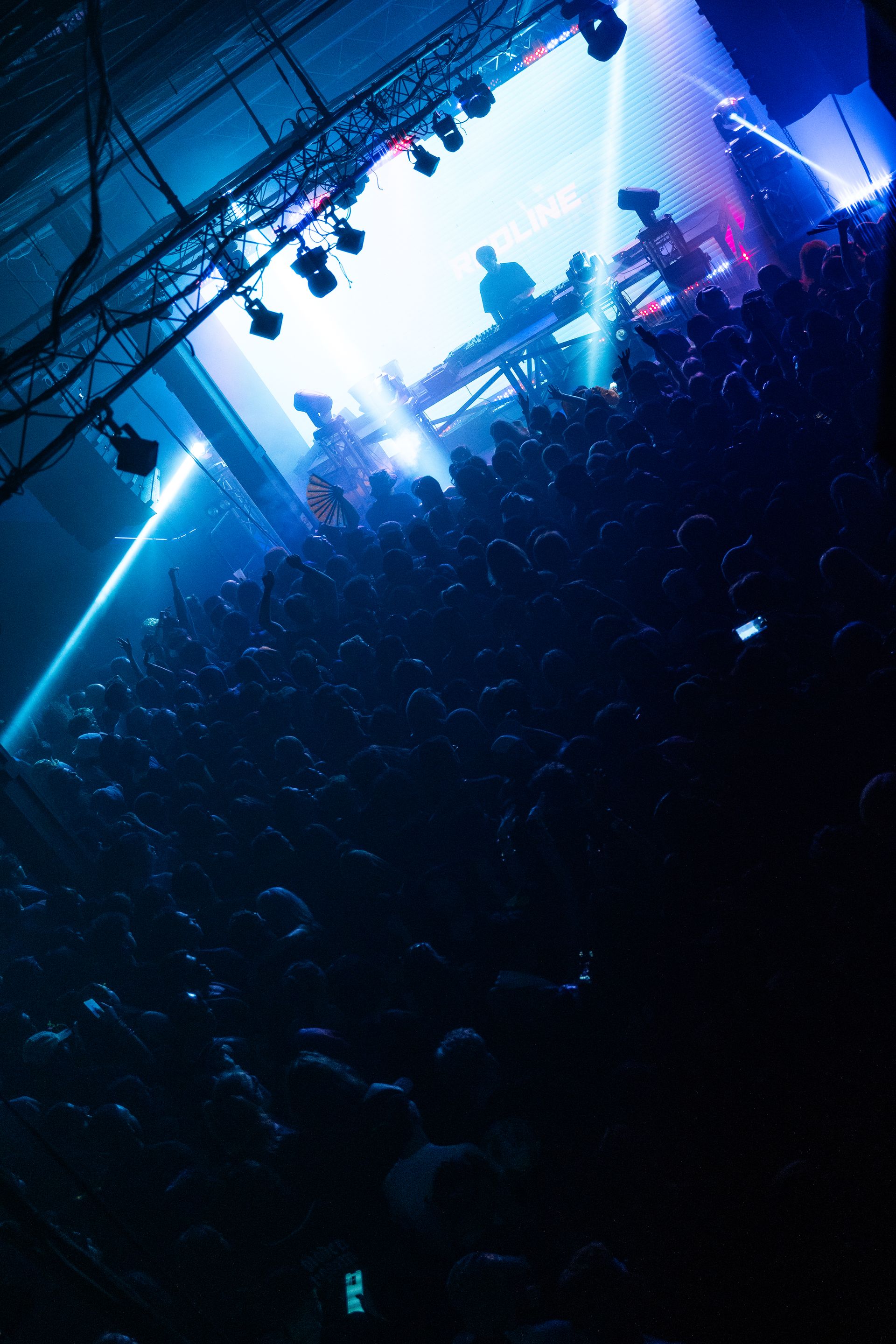 A crowd of people watching a band on stage at a concert