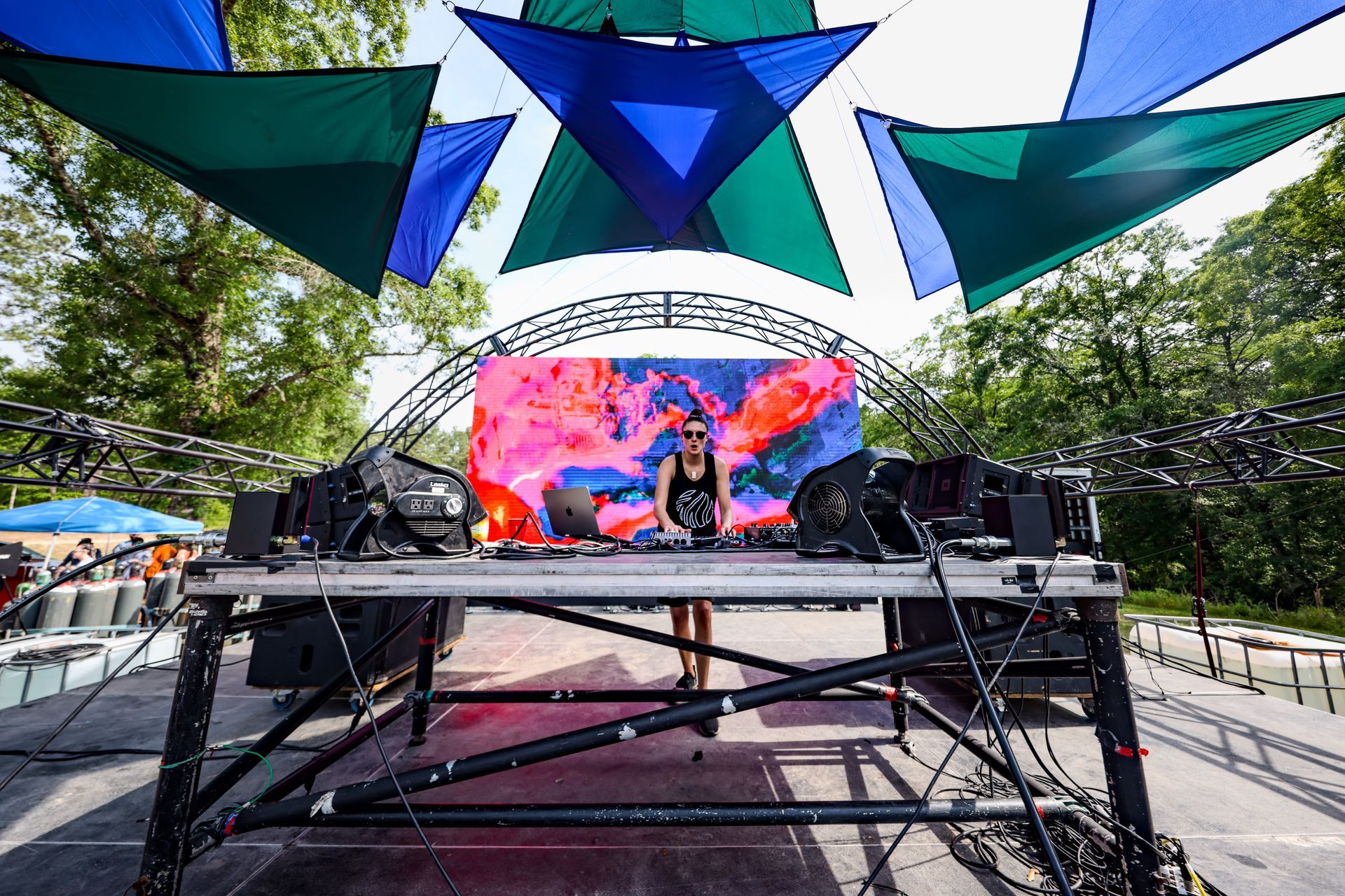 A woman is standing on a stage in front of a large screen.