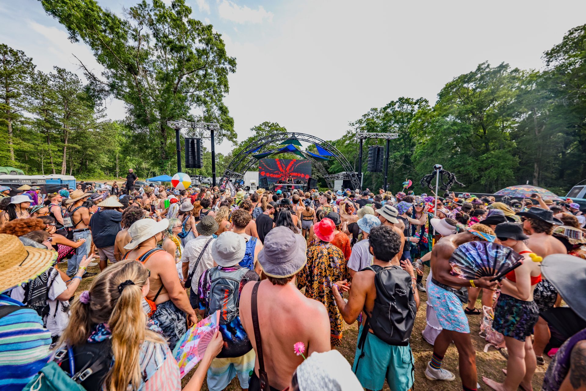 A large crowd of people are gathered at a music festival.
