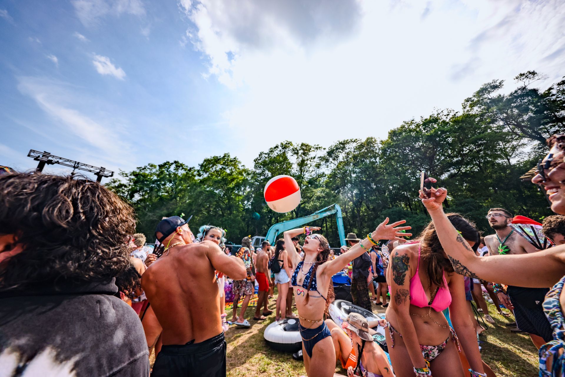 A group of people are playing with a beach ball at a party.