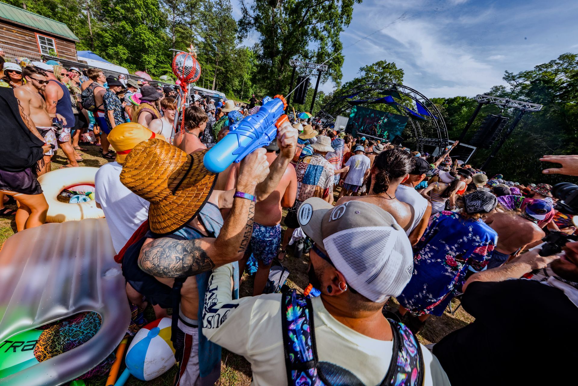 Concert goers having fun and squirting water gun