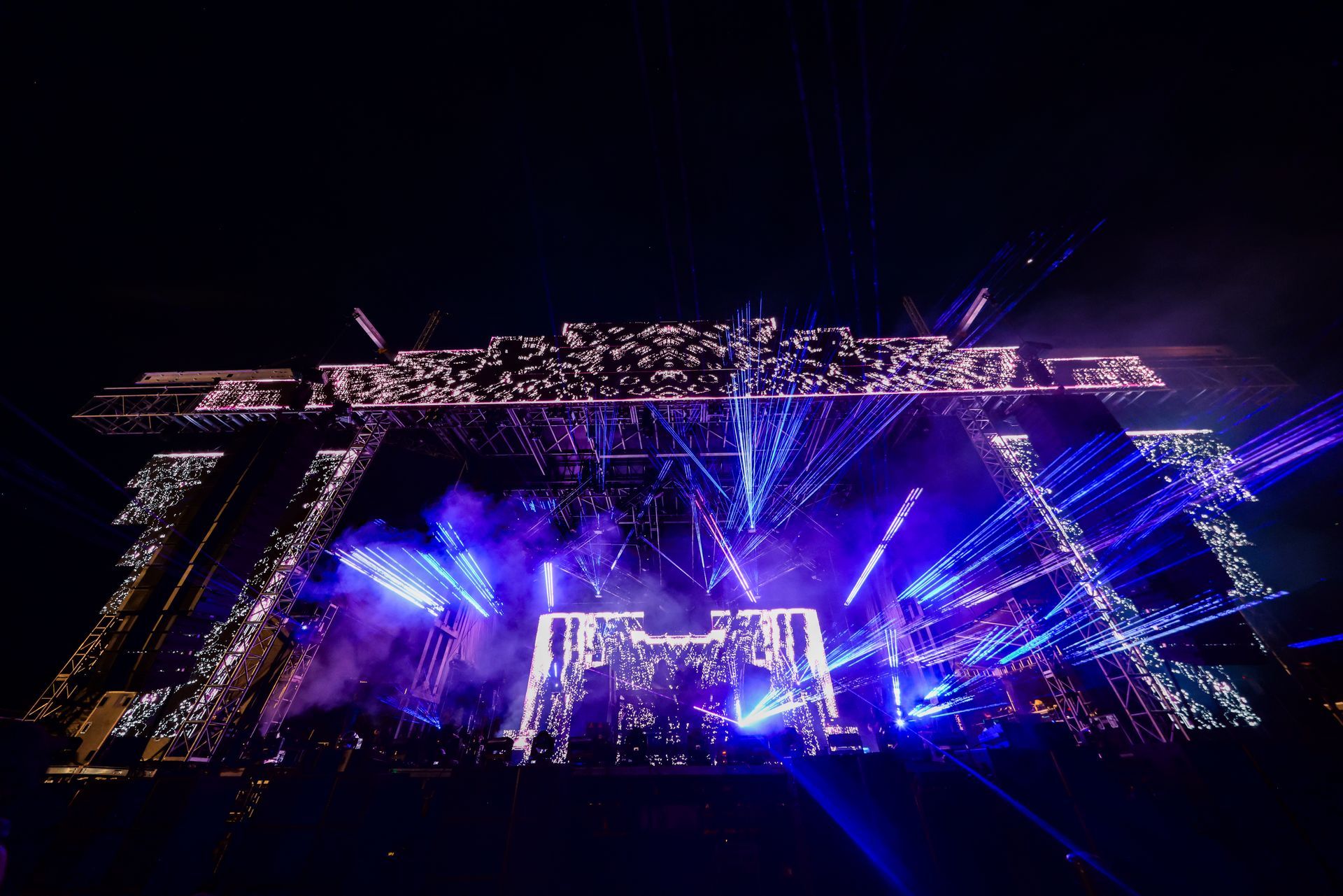 A large stage with a lot of lights on it at night.