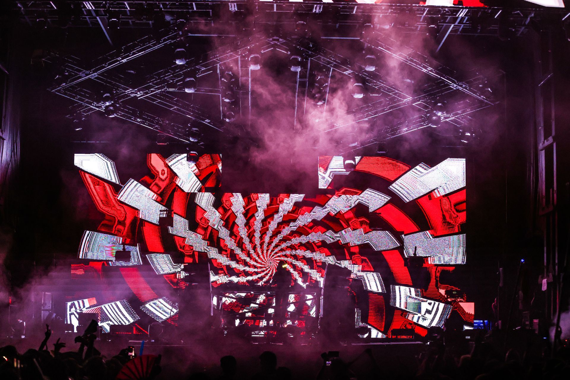 A stage with a lot of lights and smoke coming out of it