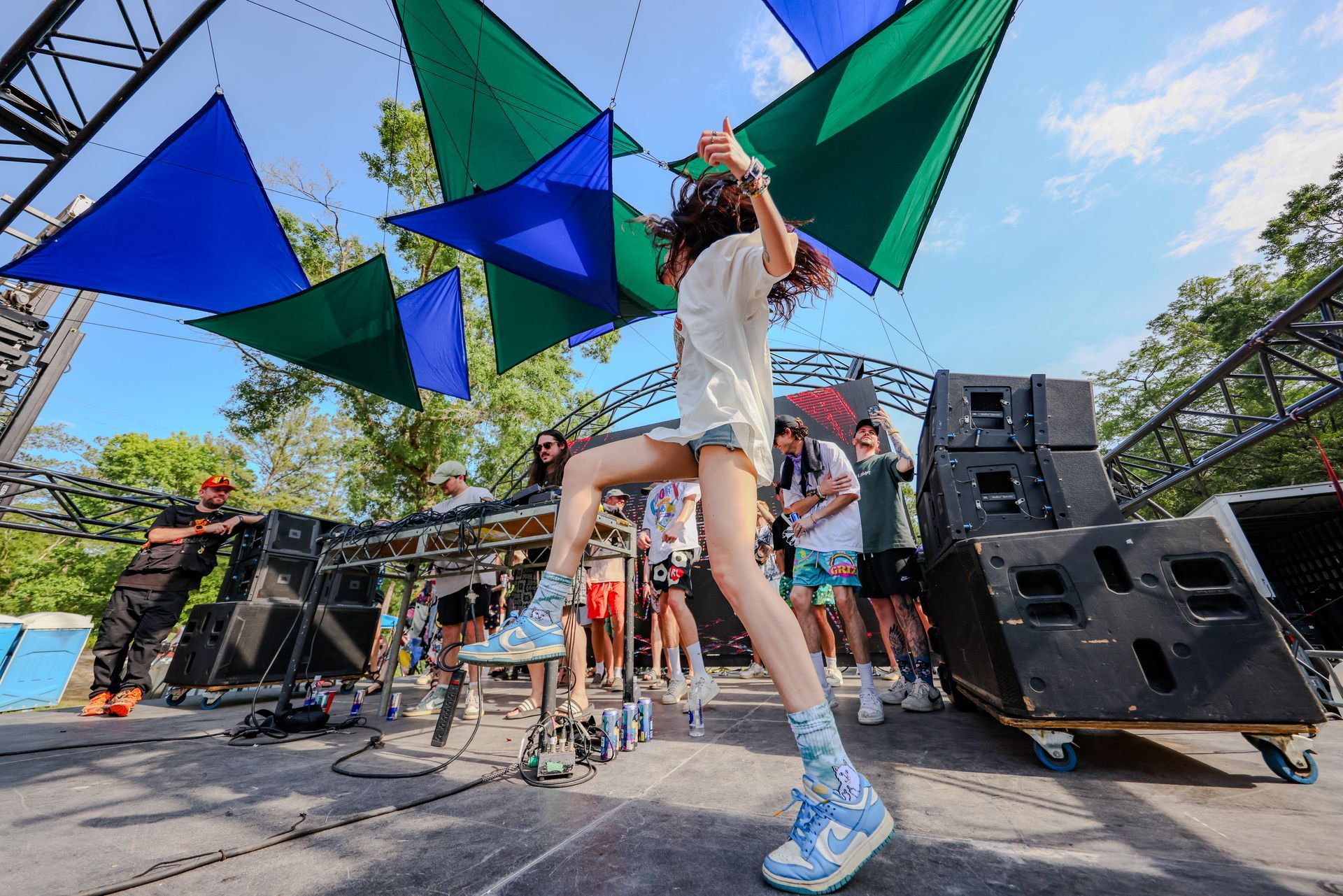A woman is dancing on a stage at a music festival.