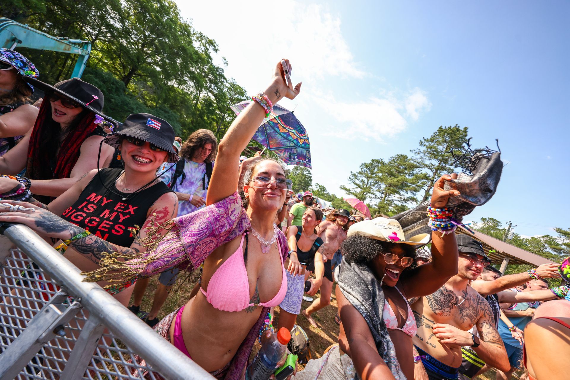 A group of people are standing in a crowd at a festival.
