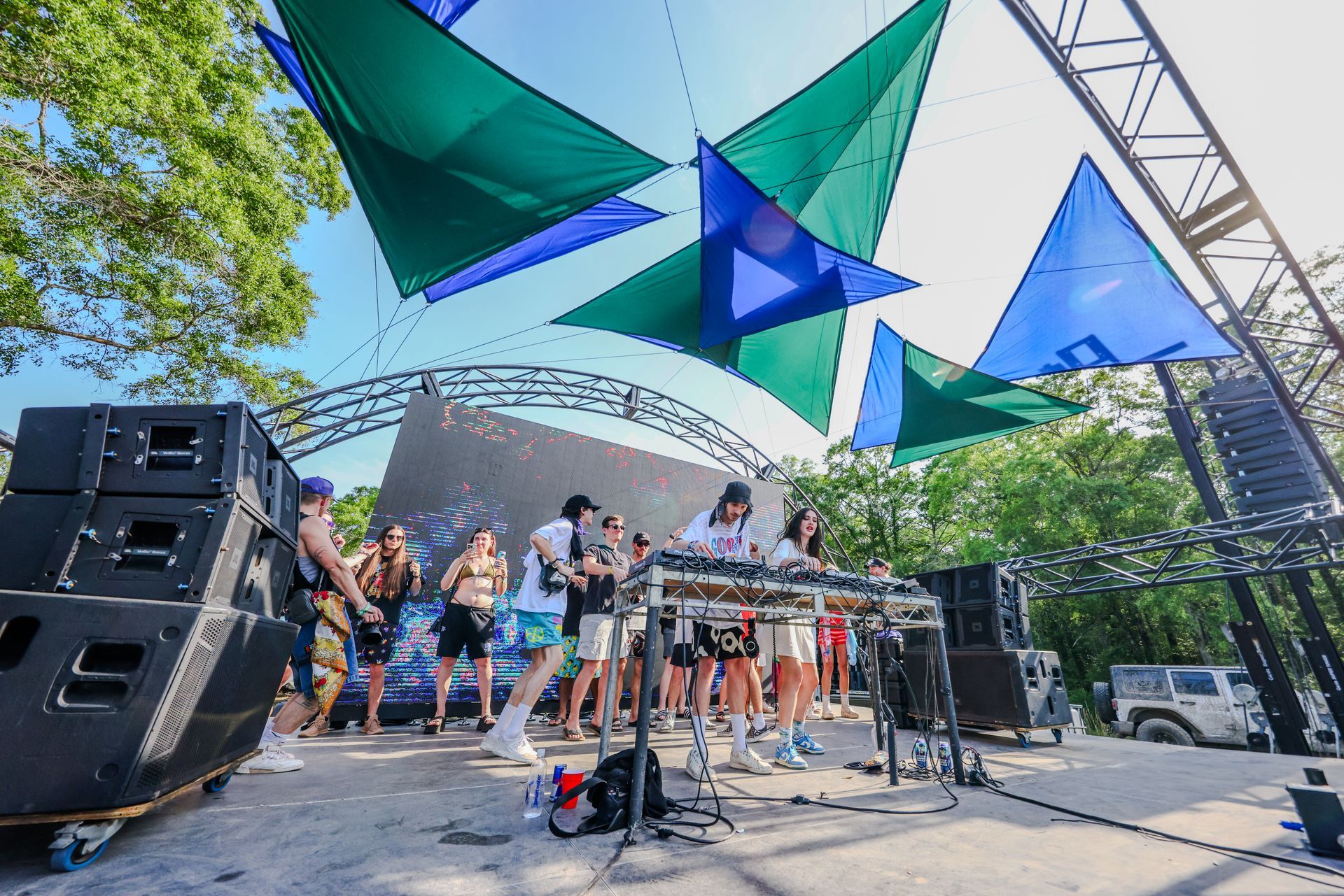 A group of people are standing on a stage at a concert.