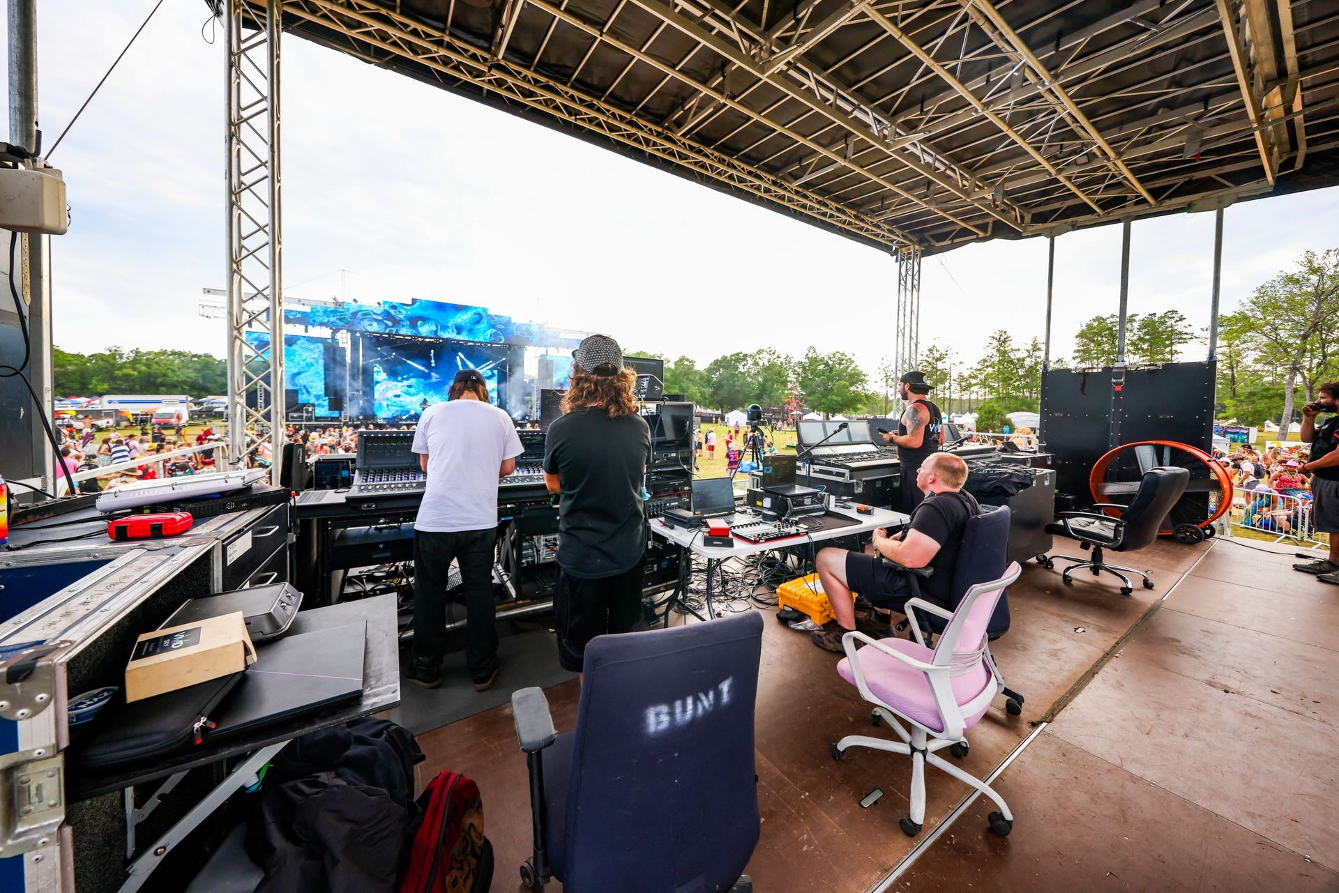A group of people are sitting in chairs in front of a stage.