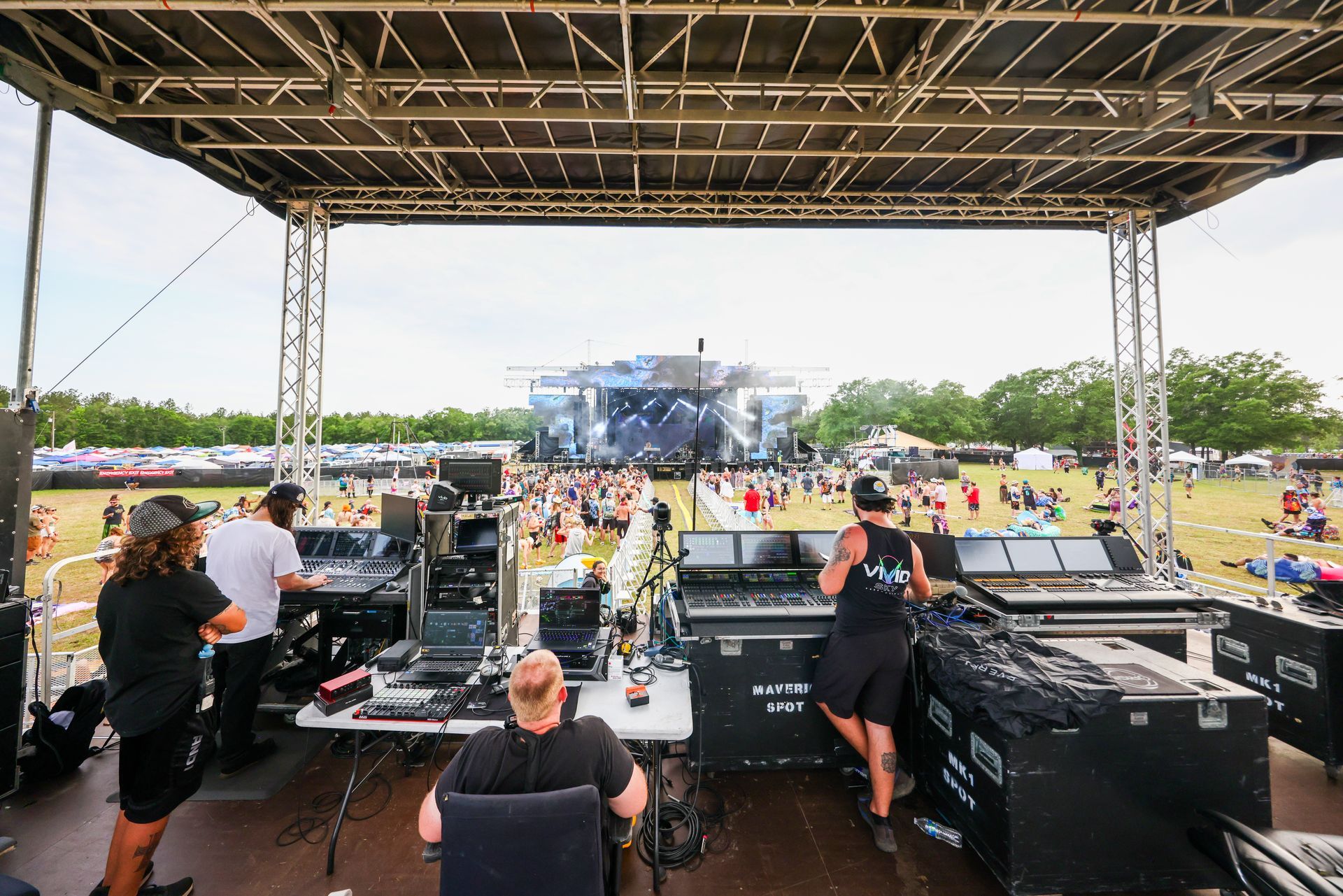 A group of people are working on a stage at a concert.