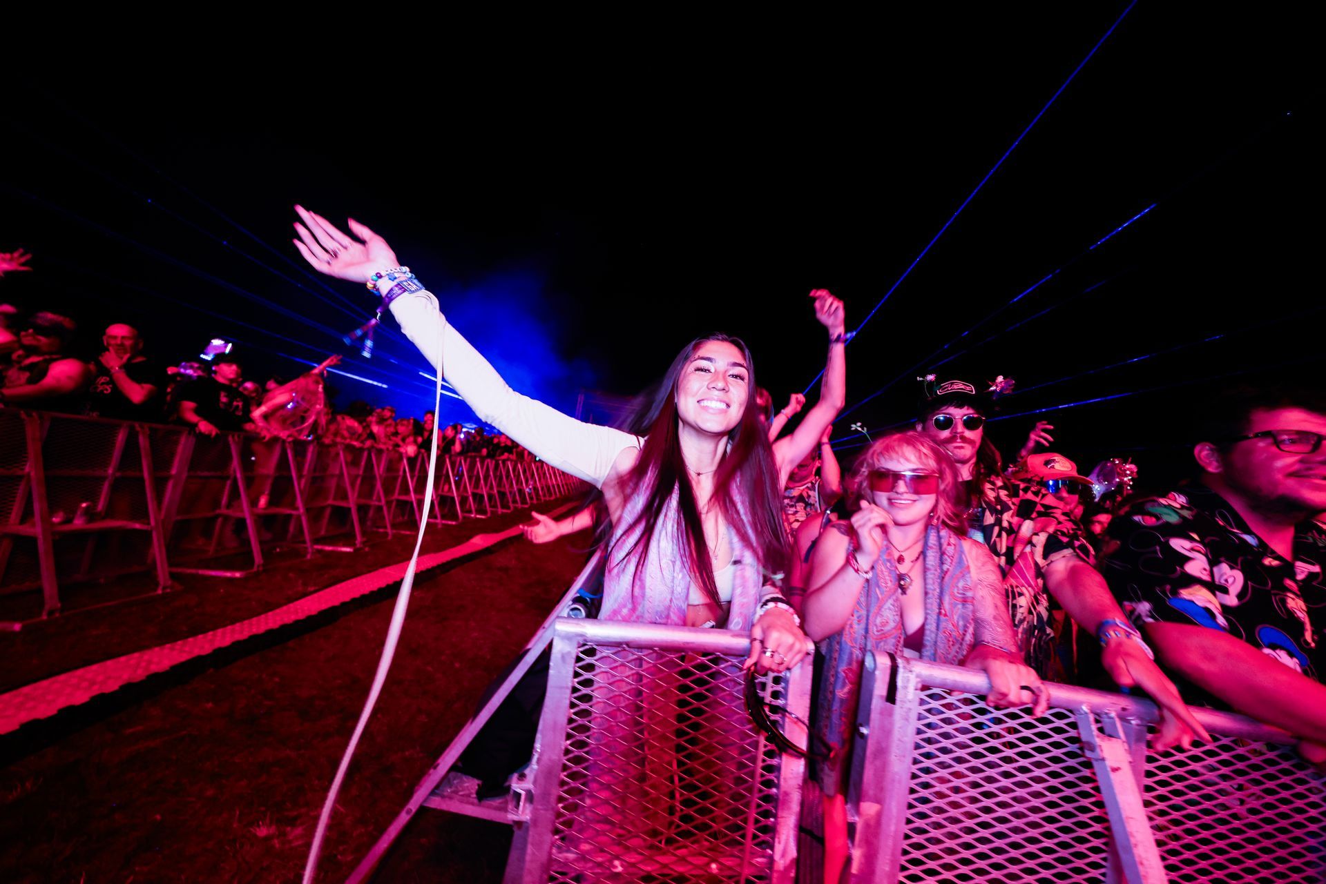 A woman is standing in front of a crowd of people at a concert.