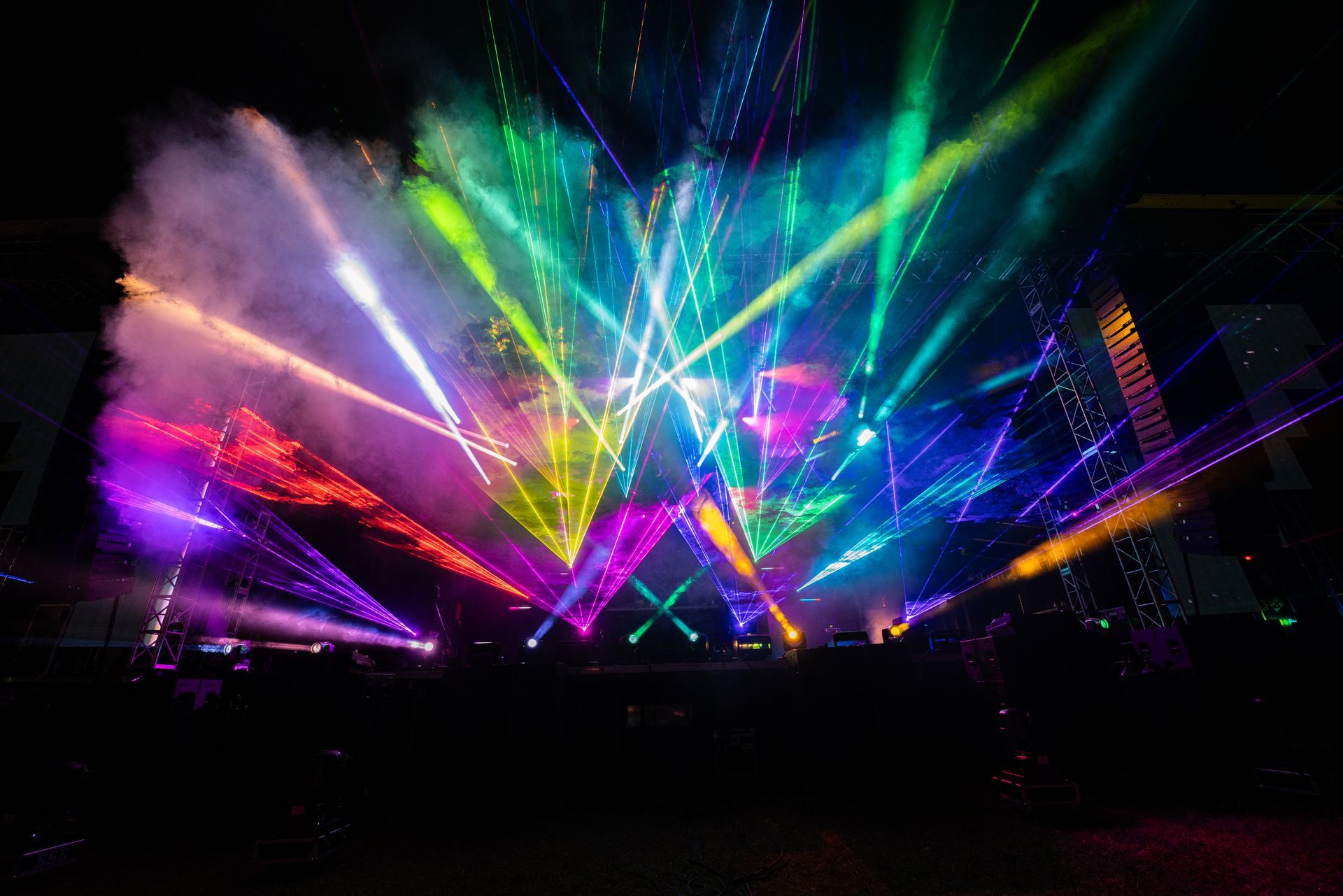 A stage with a lot of colorful lights coming out of it.