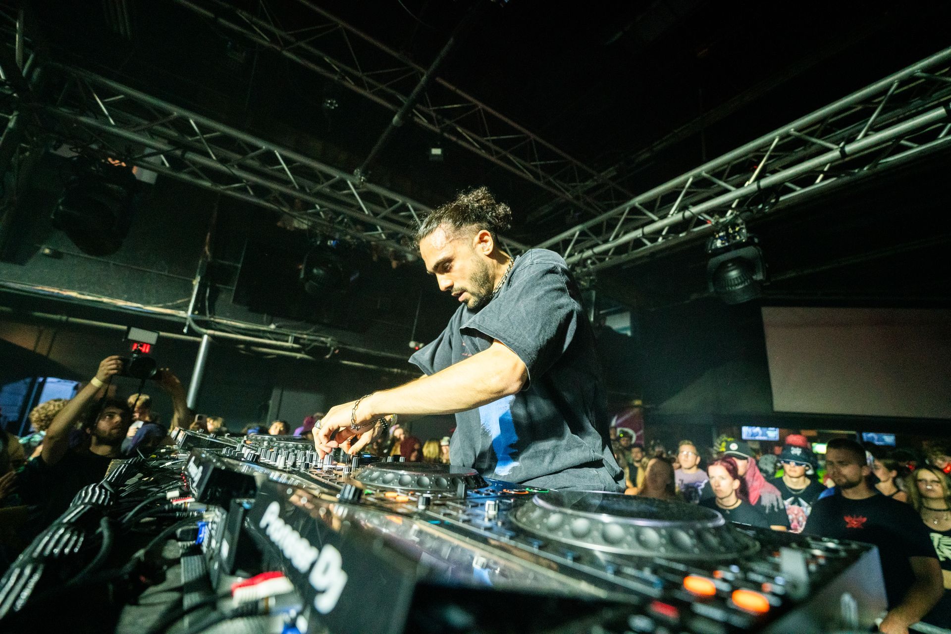 A man is playing a dj set in front of a crowd.