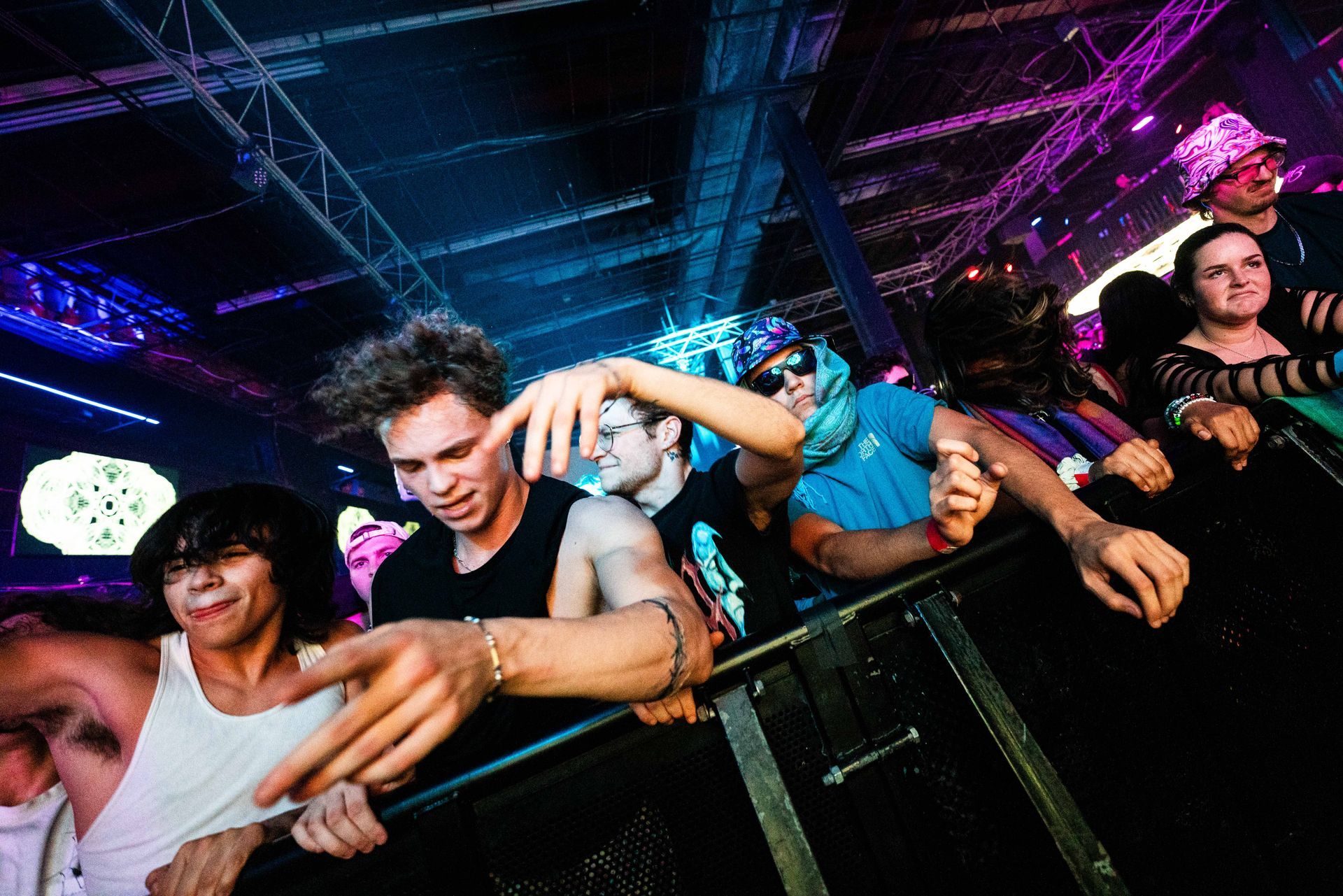 A group of people are standing in a crowd at a concert.