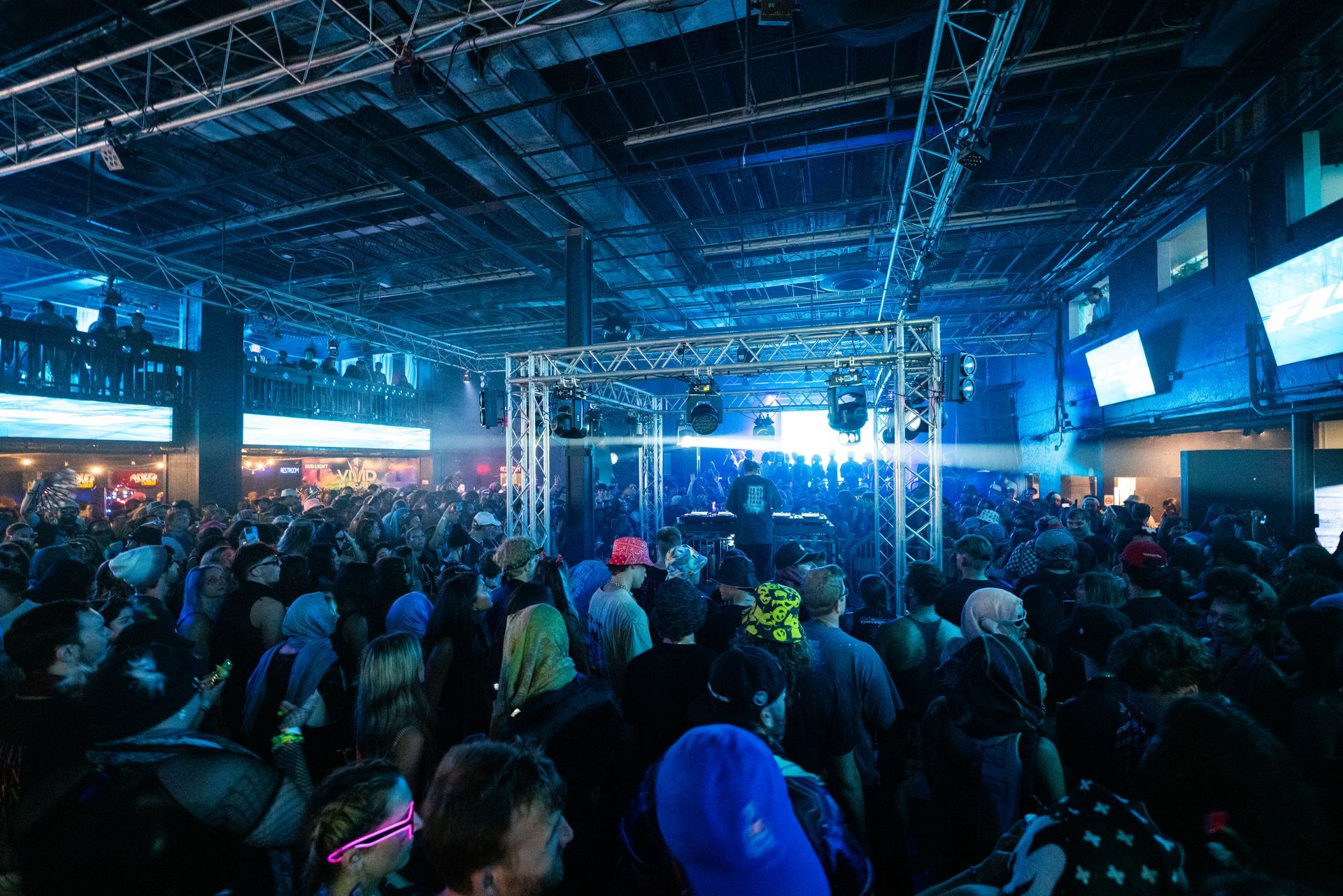A crowd of people are gathered in a large room at a concert