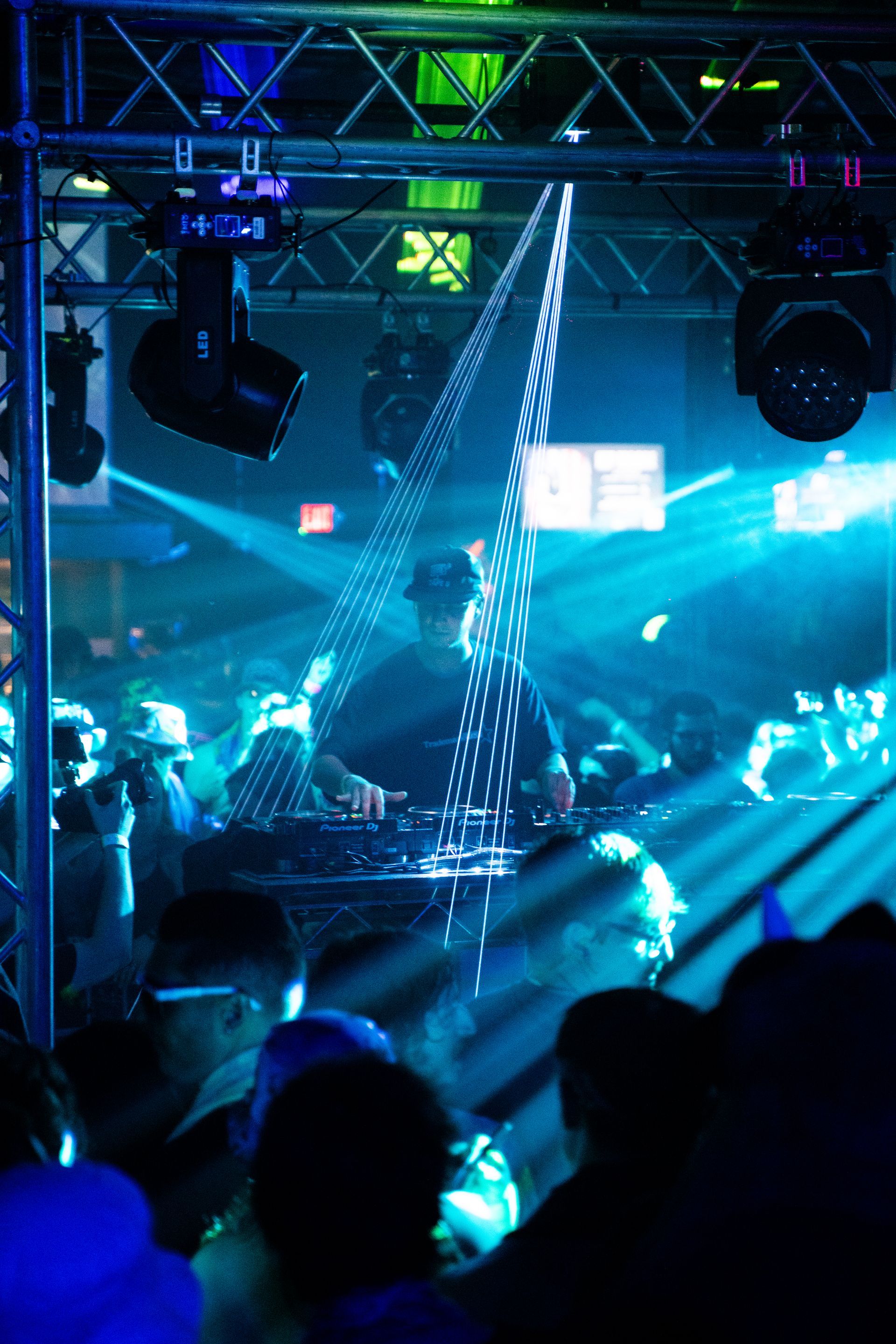 A dj is playing music in front of a crowd at a party