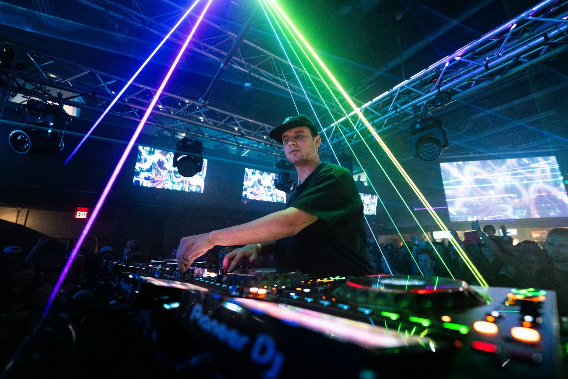 A man is playing a dj set in a club.